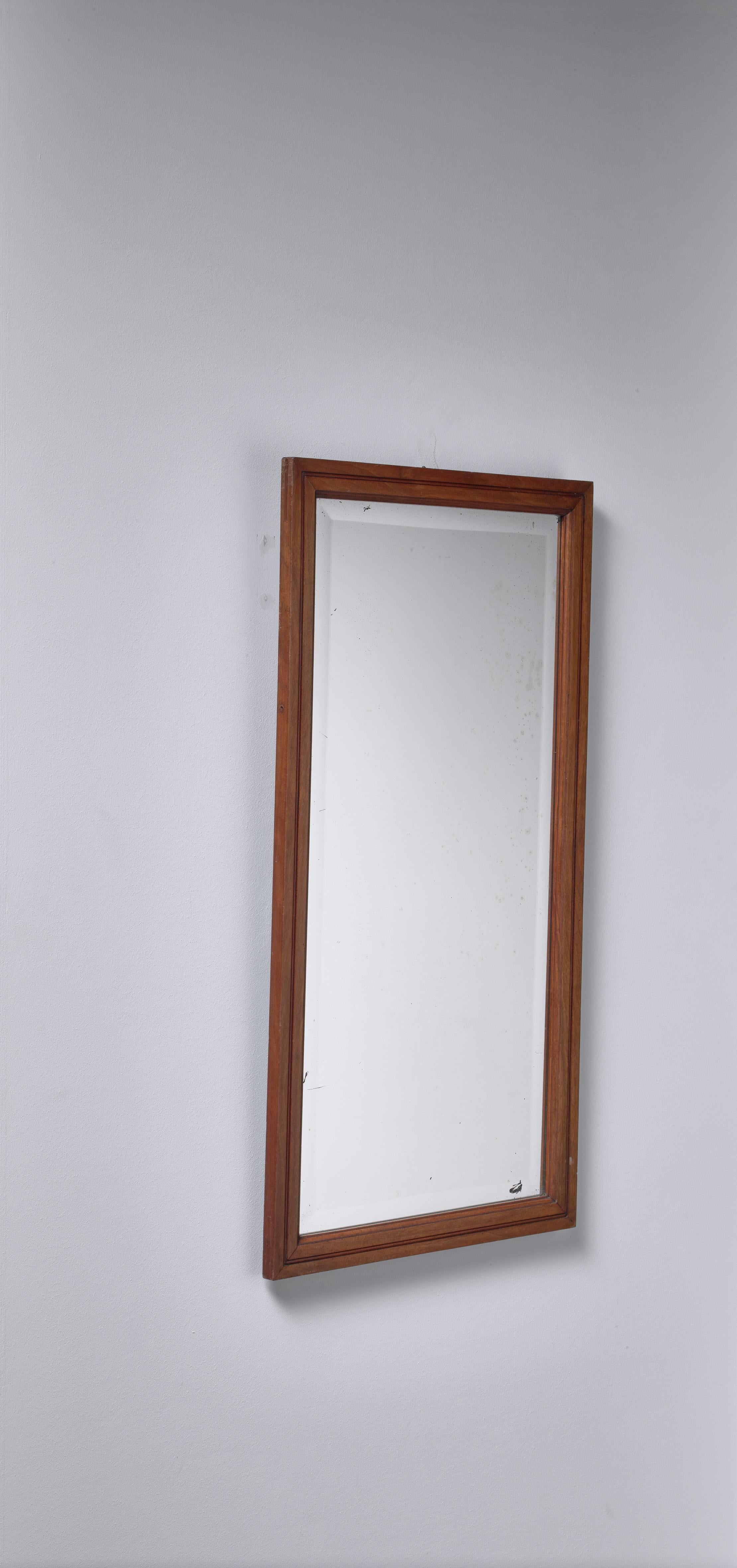 A late 19th century or early 20th century Swedish mirror in a profiled mahogany frame. Ideal to be used in a bathroom or in a hallway.