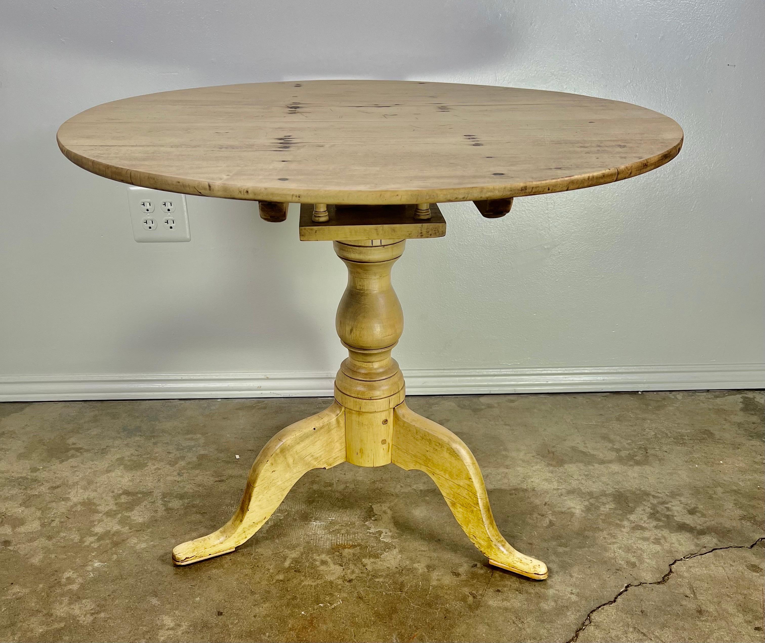 19th century maple tripod table. A round top sits on a tripod base with the original tilting mechanism. The table does not tilt at this point, but the detail is great. The table is sturdy and in good working condition. The wear is consistent with