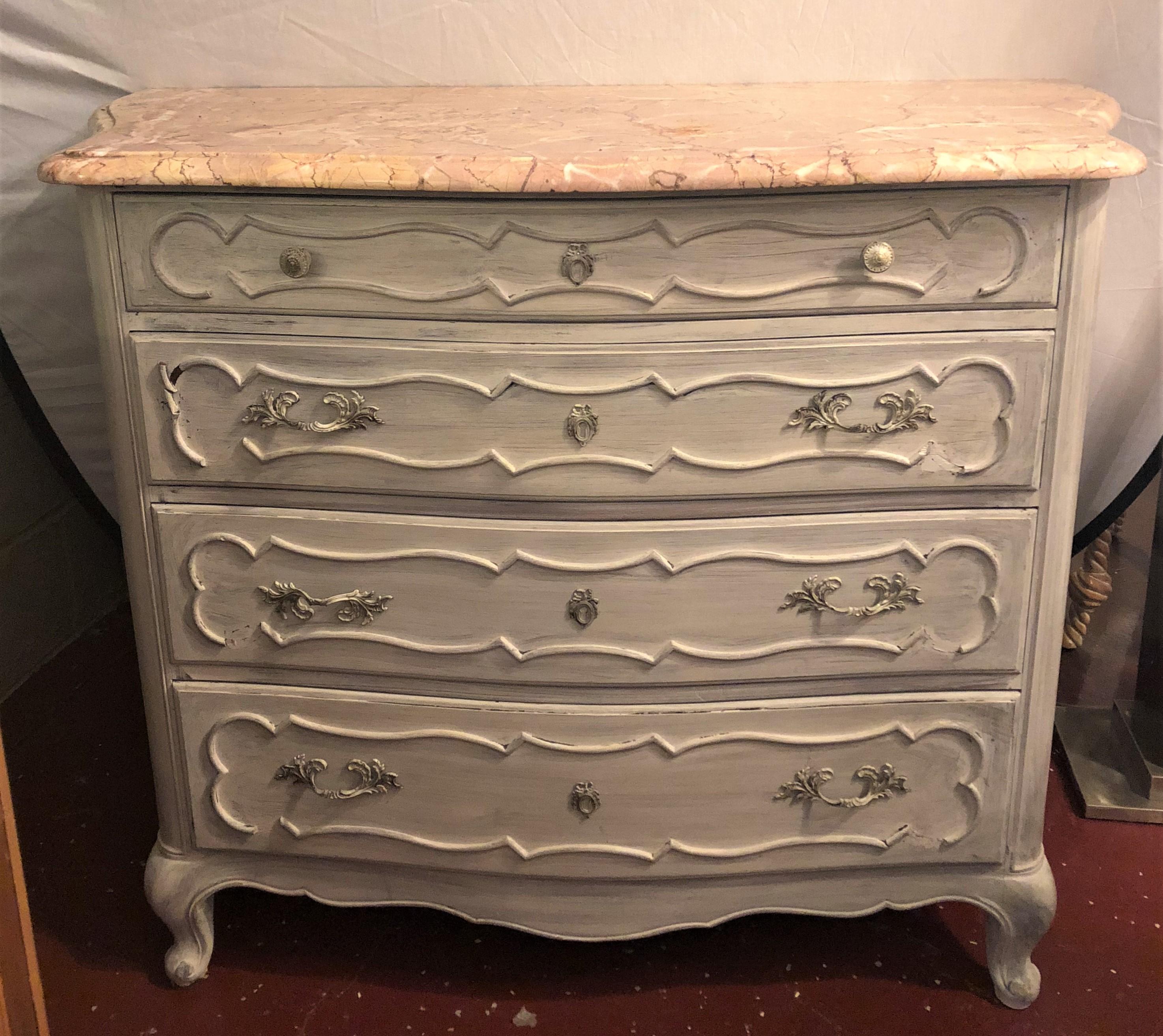 Swedish marble-top four-drawer chest or commode / nightstand. This antiqued French commode or night table has been finished in a fine Swedish painted finish and supports a wonderfully grained marble top.