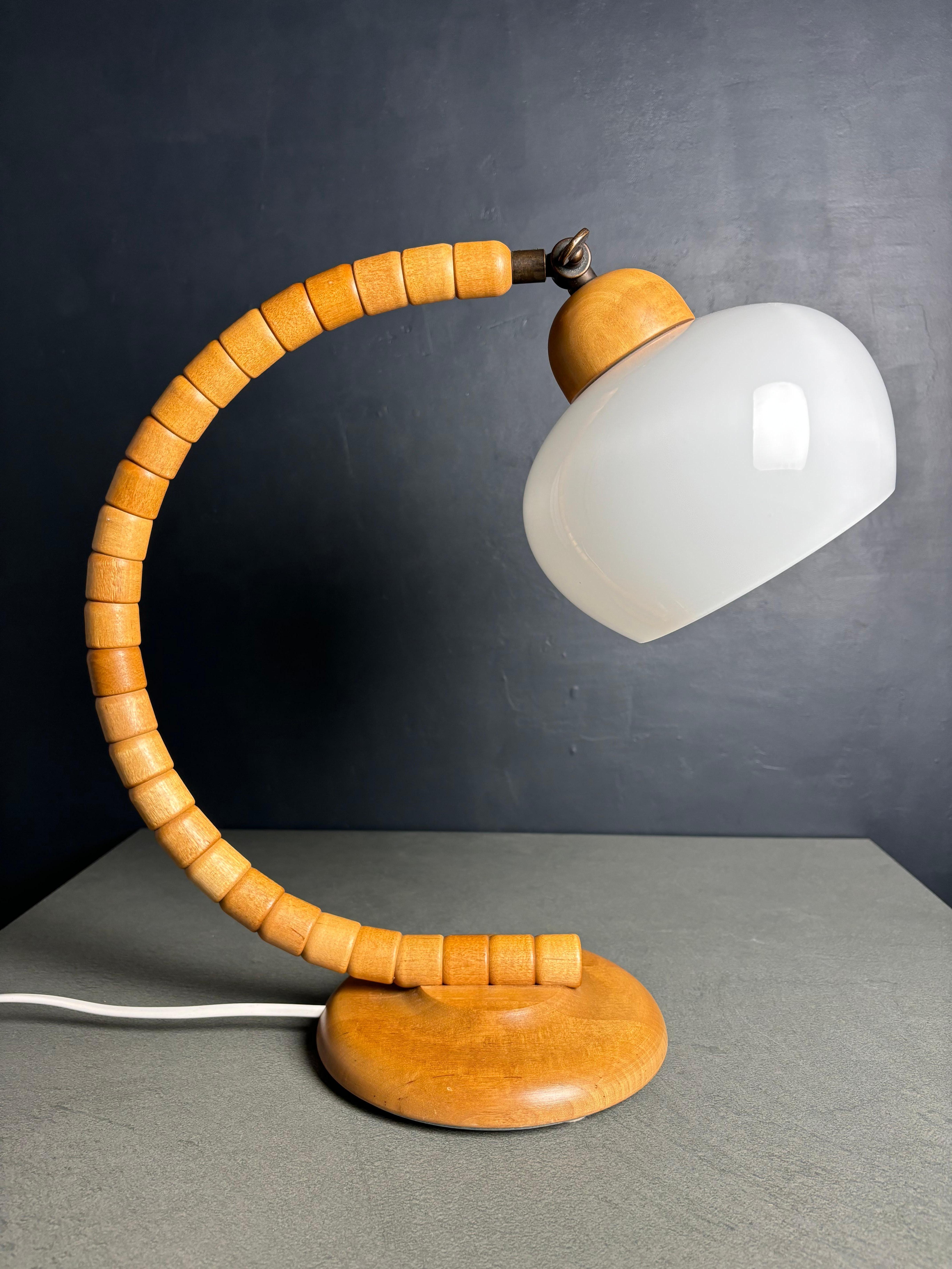 Escultural lámpara de sobremesa de estilo art déco y formas orgánicas, diseñada y fabricada por la sueca Markslöjd en la década de 1960. Las capas de piezas de madera maciza de haya lacada transparente de color claro crean una gran forma