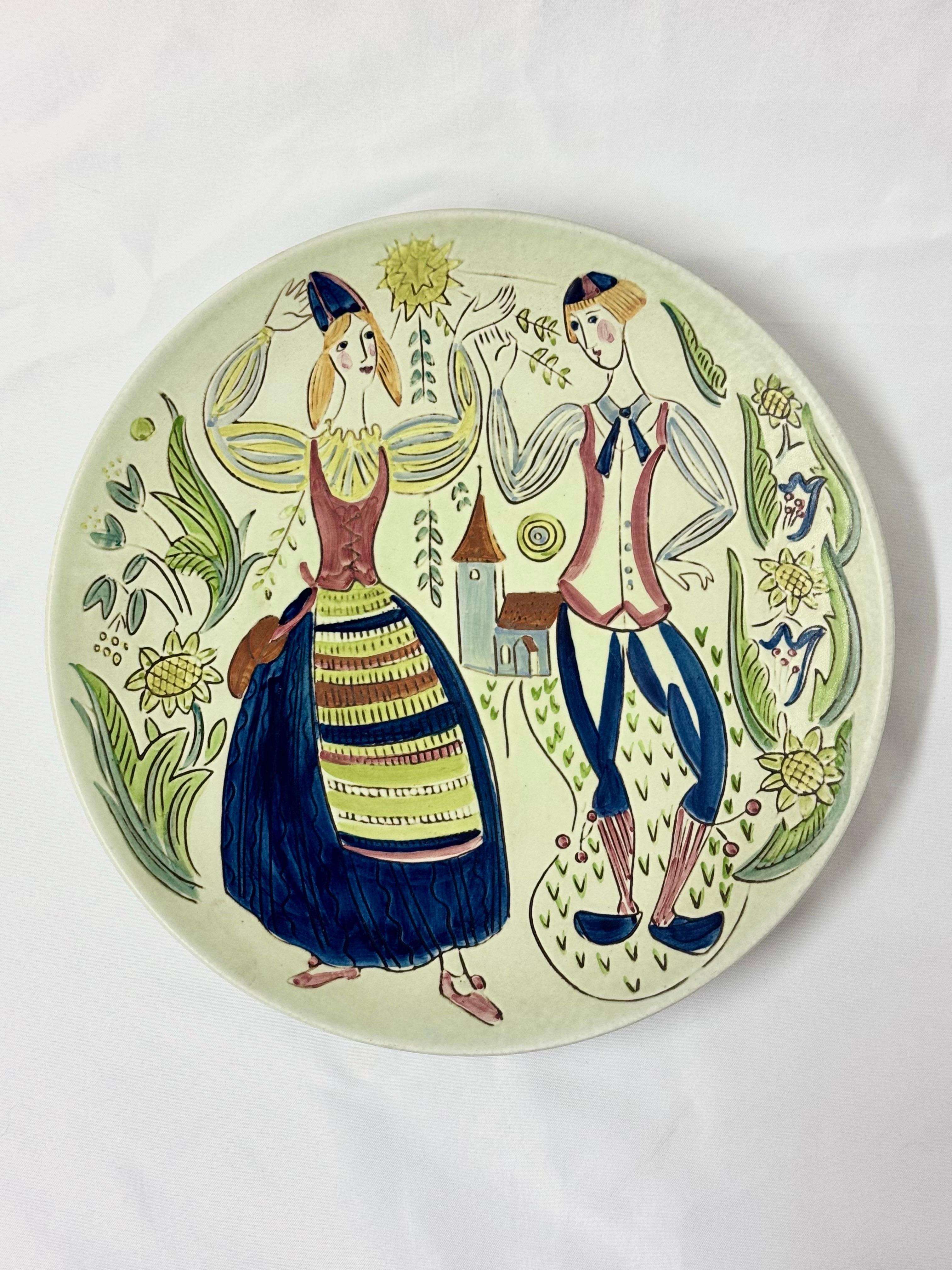 Swedish MCM wall charger by Carl Harry Stalhane for Rorstrand . Gorgeous colorful piece of Swedish folk art pottery . It can also be hung as this charger and has a copper wire loop attached in the back. Depth 1.75