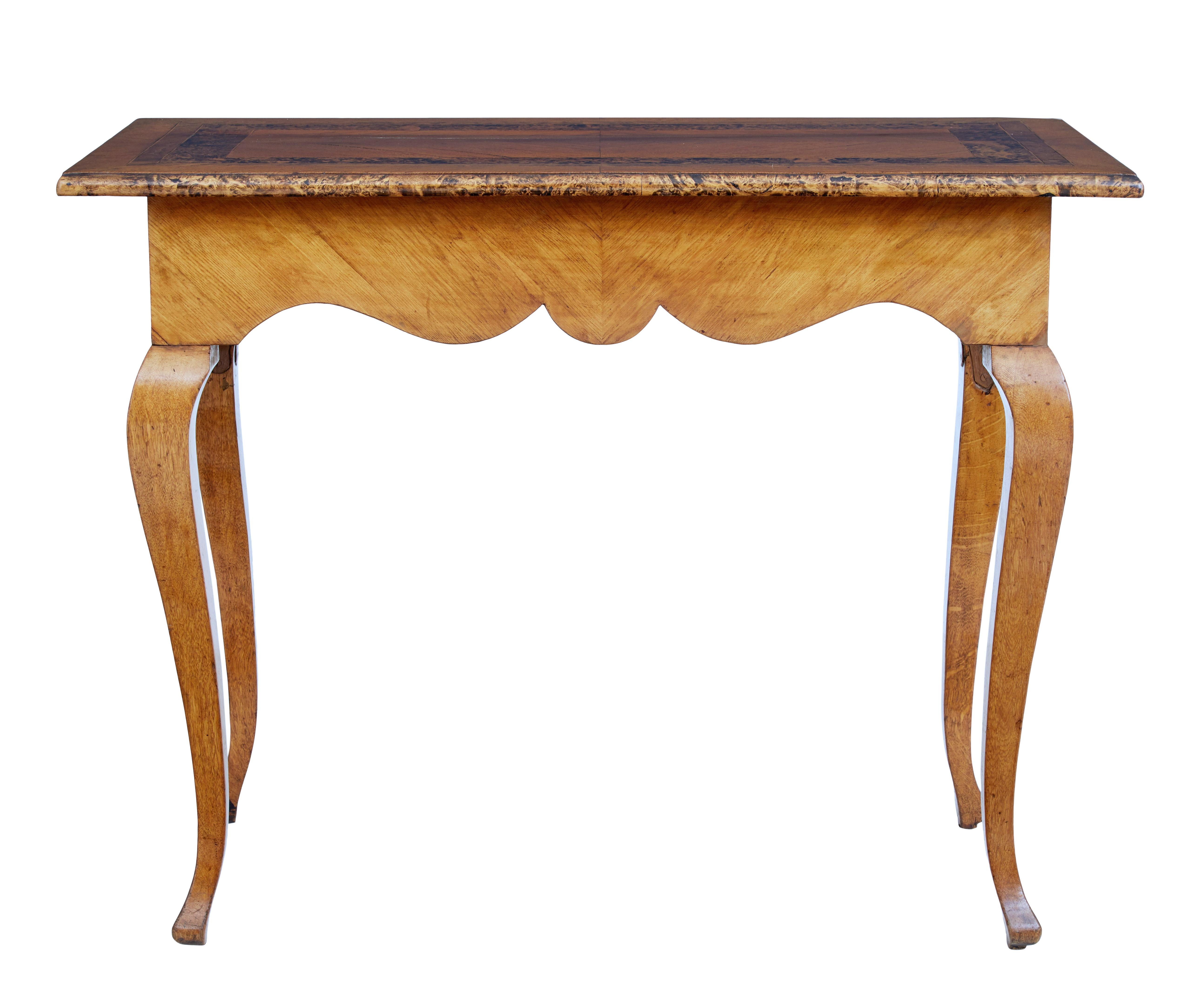 Swedish mid 19th century alder root occasional table, circa 1850.

Elegant piece of mid 19th century furniture from Sweden. Over sailing top with alder root outer edge and alder cross banding with stringing. Rare feature of having a drawer each