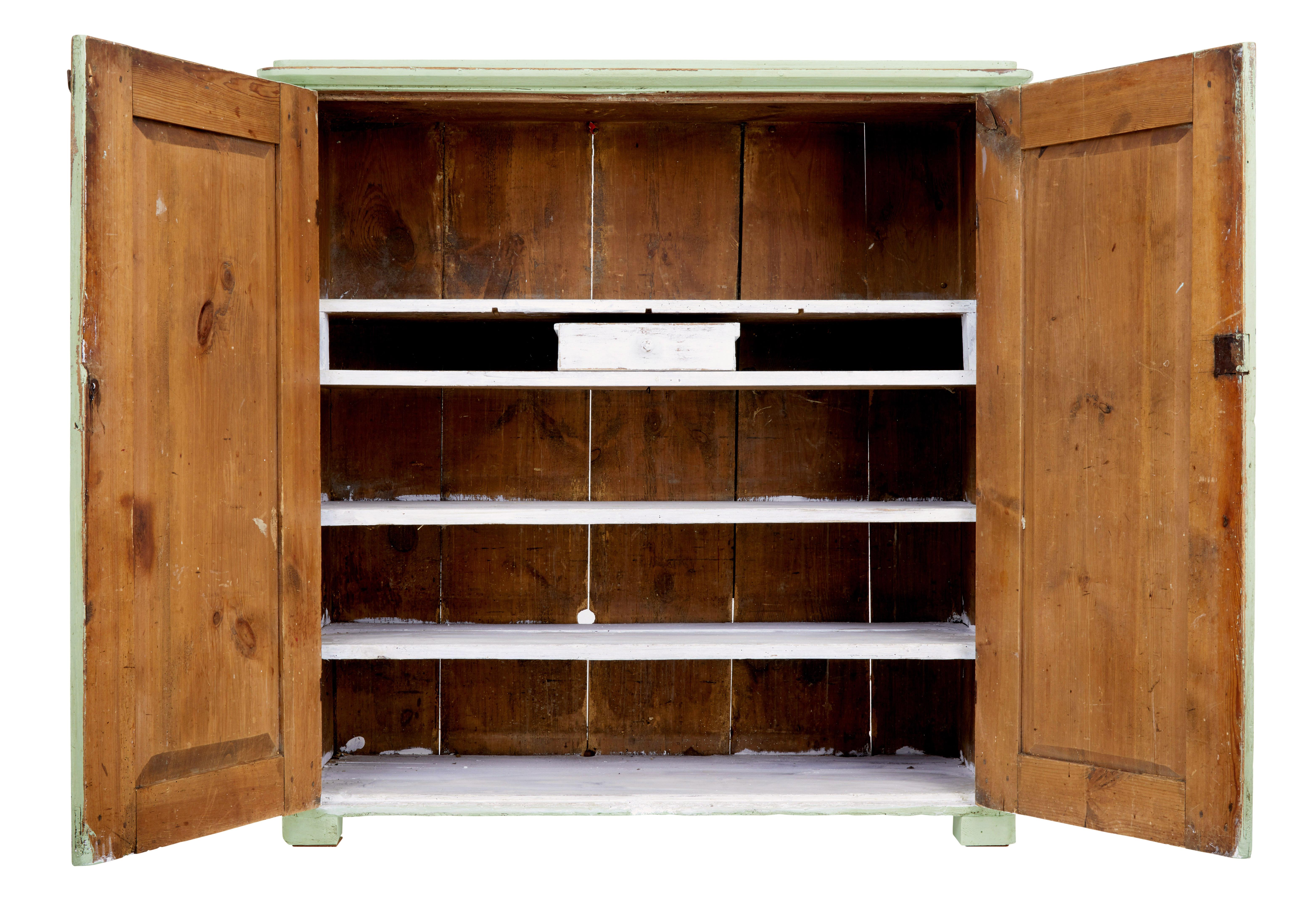 Rustic Swedish kitchen cupboard circa 1850.

Traditional pine double door cupboard which opens to 4 shelves which have been painted white.  There is also a loose fitting drawer.

Ideal for use in multiple rooms around the home, such as the kitchen