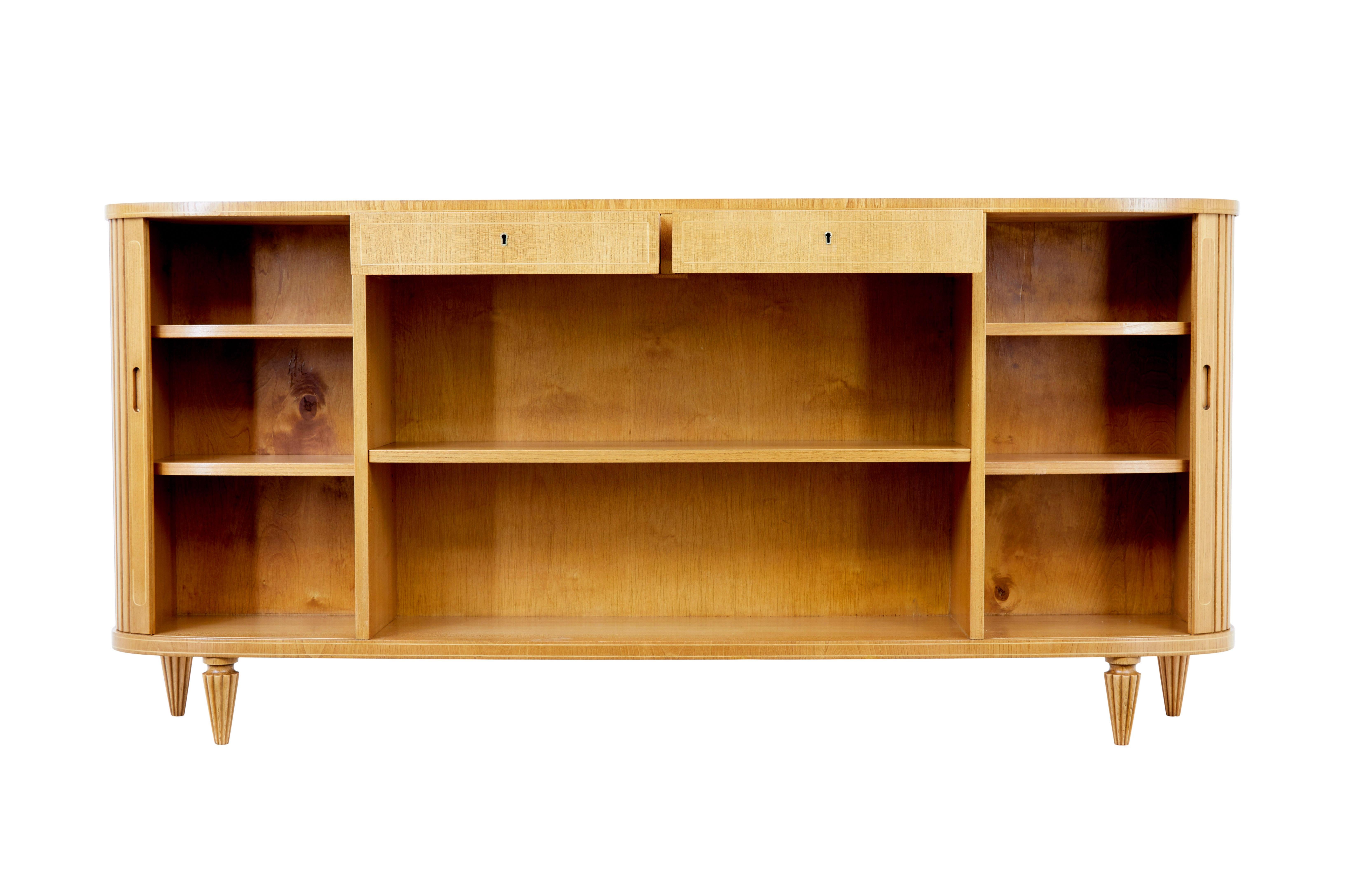 Swedish mid 20th century elm tambour front low open bookcase circa 1950.

We are pleased to offer this fine piece of scandinavian design which has been fully restored in our workshop,  with it's generous length and narrow depth, it provides the