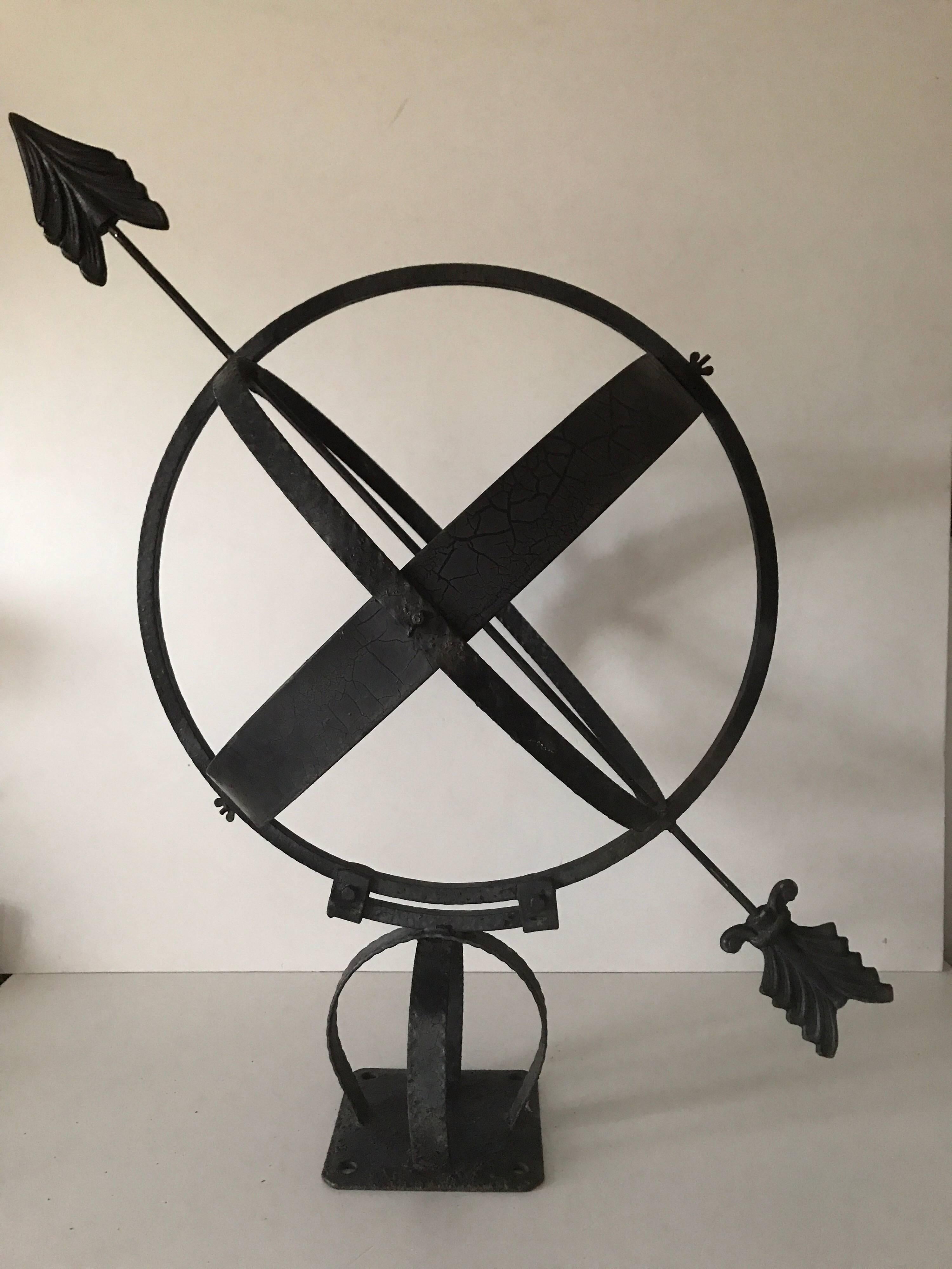 Swedish Mid-20th century wrought iron and copper garden sundial.
Another beautiful sundial that we have for sale, this one is painted black and have copper dials with an arrow across the sphere. The arrowhead and tail is made of cast aluminum. The