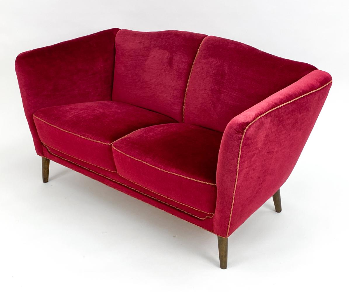 Transport yourself to an era of unparalleled elegance and design with the Swedish Mid-Century Beech & Red Mohair Sofa. A sublime ode to the 1950s, this piece flawlessly embodies the spirit and artistry of its time, making it a must-have for any