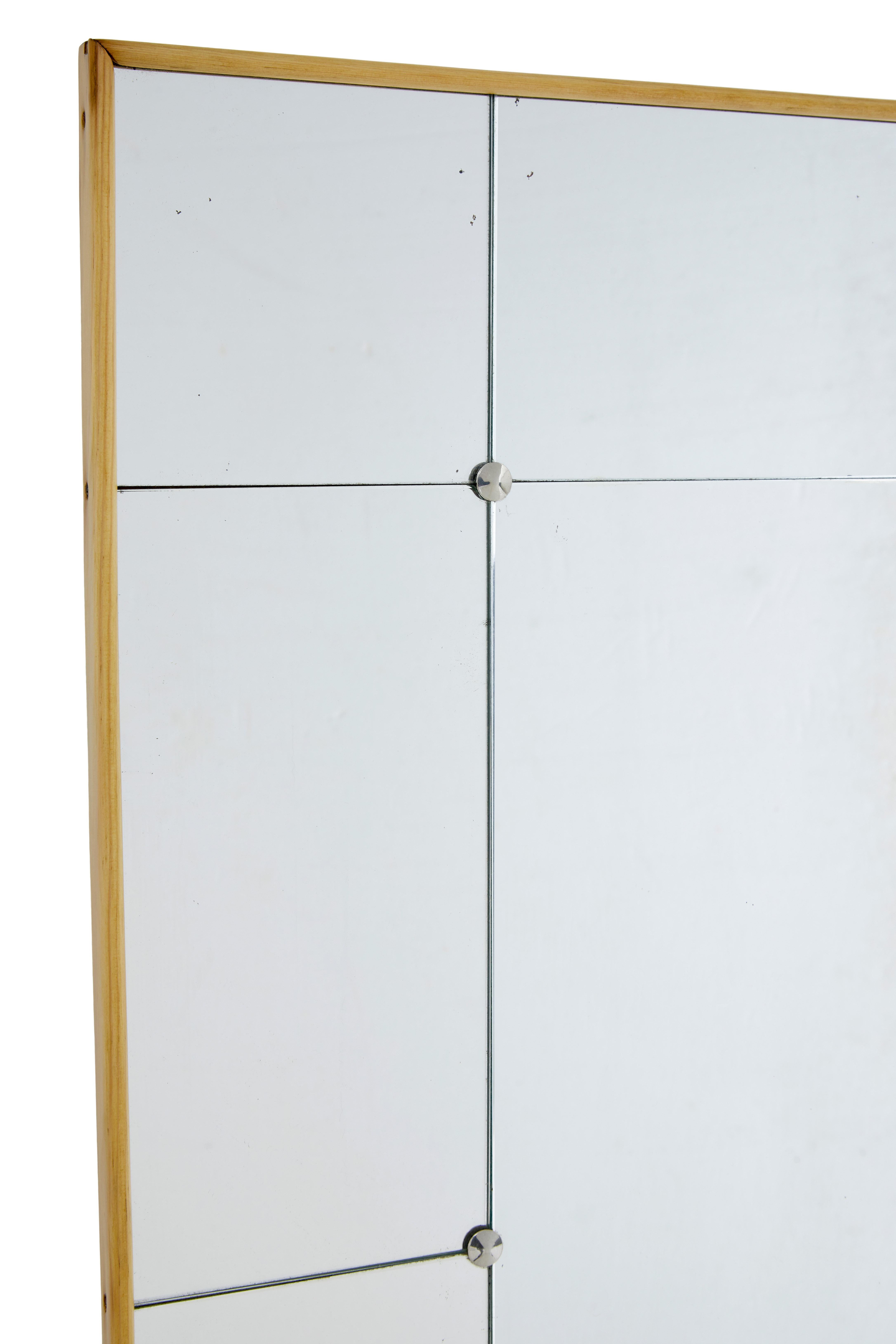 Swedish mid century beech wall mirror circa 1960.

Wall mirror ideal for use in the bedroom or bathroom. Small rectangular central mirror surrounded by further smaller rectangular mirror's, held in place by chromed screw in studs.  Presented in a