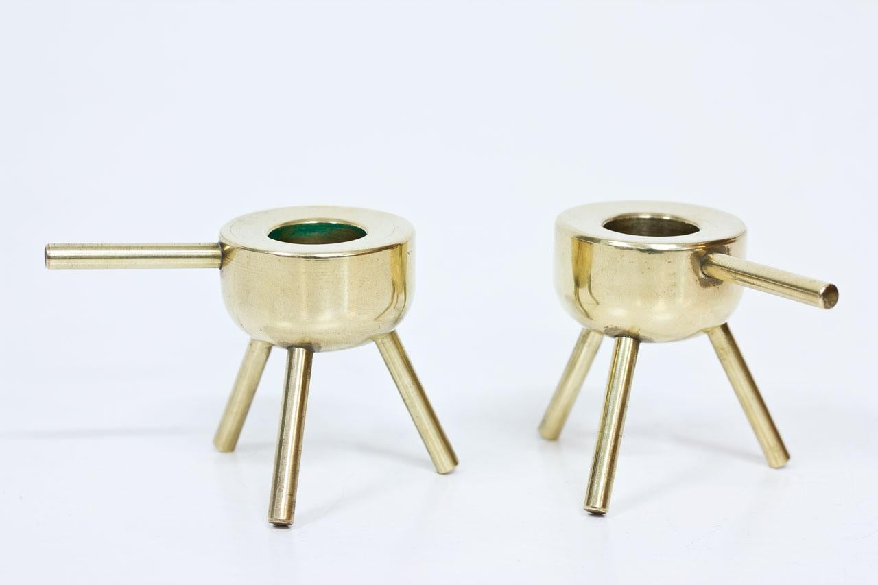 Pair of minimalist solid polished brass candlesticks. Most likely manufactured during the 1950s in Sweden. Suitable for large candles (2cm diameter).