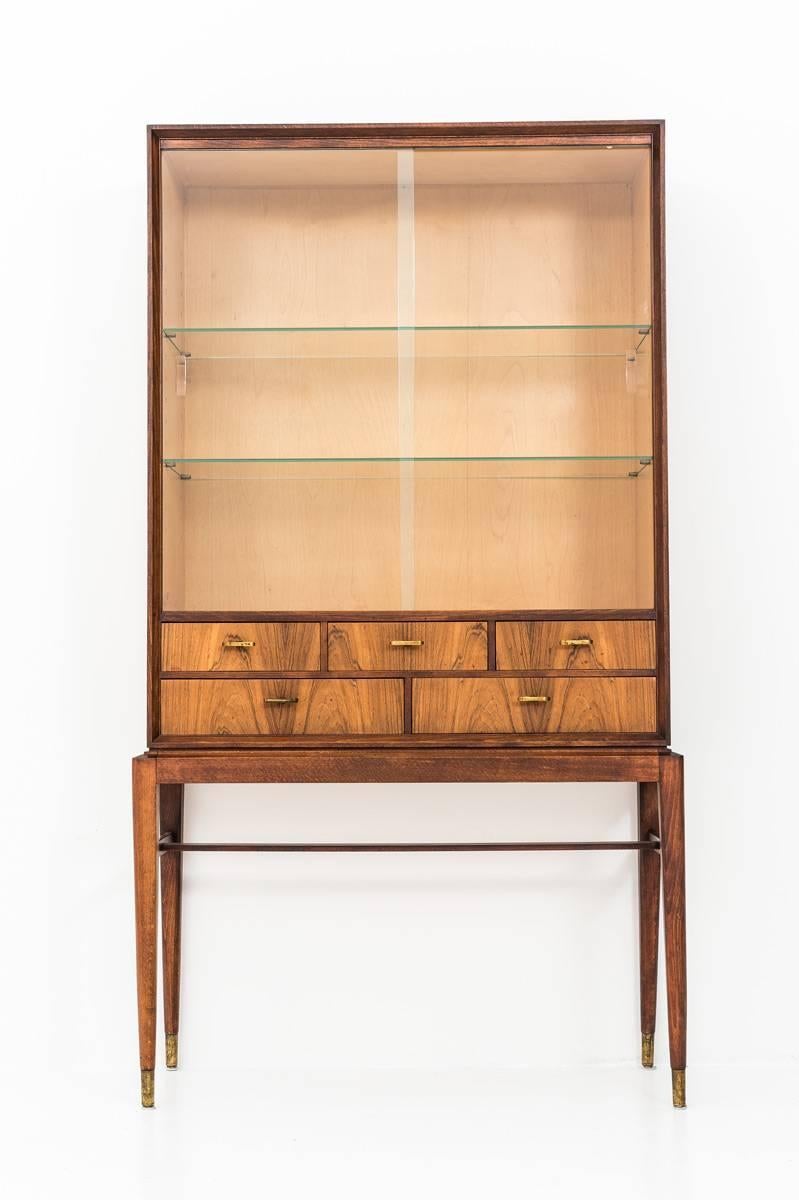 A beautiful cabinet by Svante Skogh for Seffle Möbelfabrik, Sweden. 
This piece features a rosewood and teak frame with two large sliding glass doors and five drawers with handles in brass. 

Condition: Very good vintage condition with normal