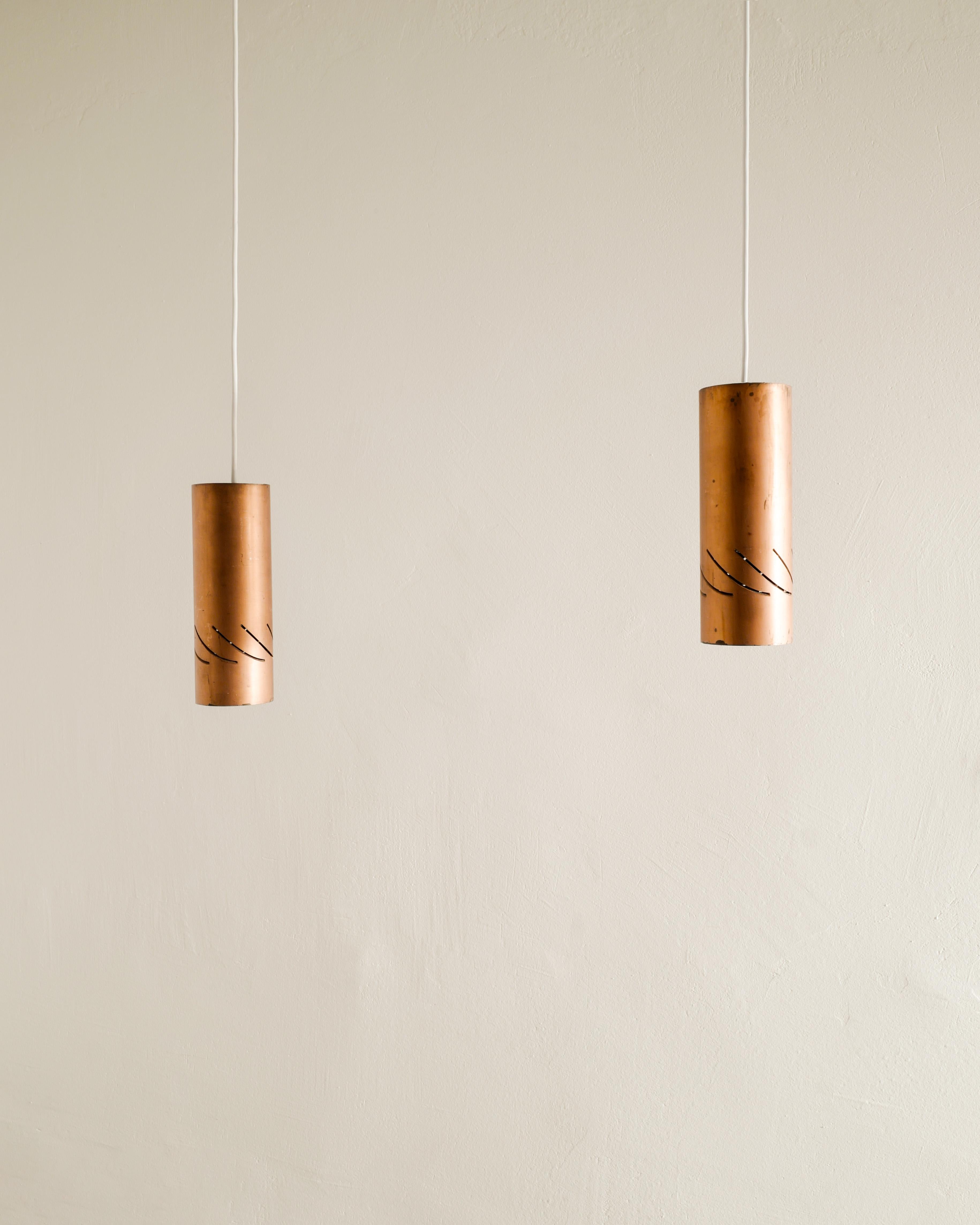 Rare and great set of four mid century copper cylinder pendants by anonymous designer produced in Sweden, 1960s. In good original condition with patina from age and use. Four pendants available. 

Dimensions: H: 23 cm / 9