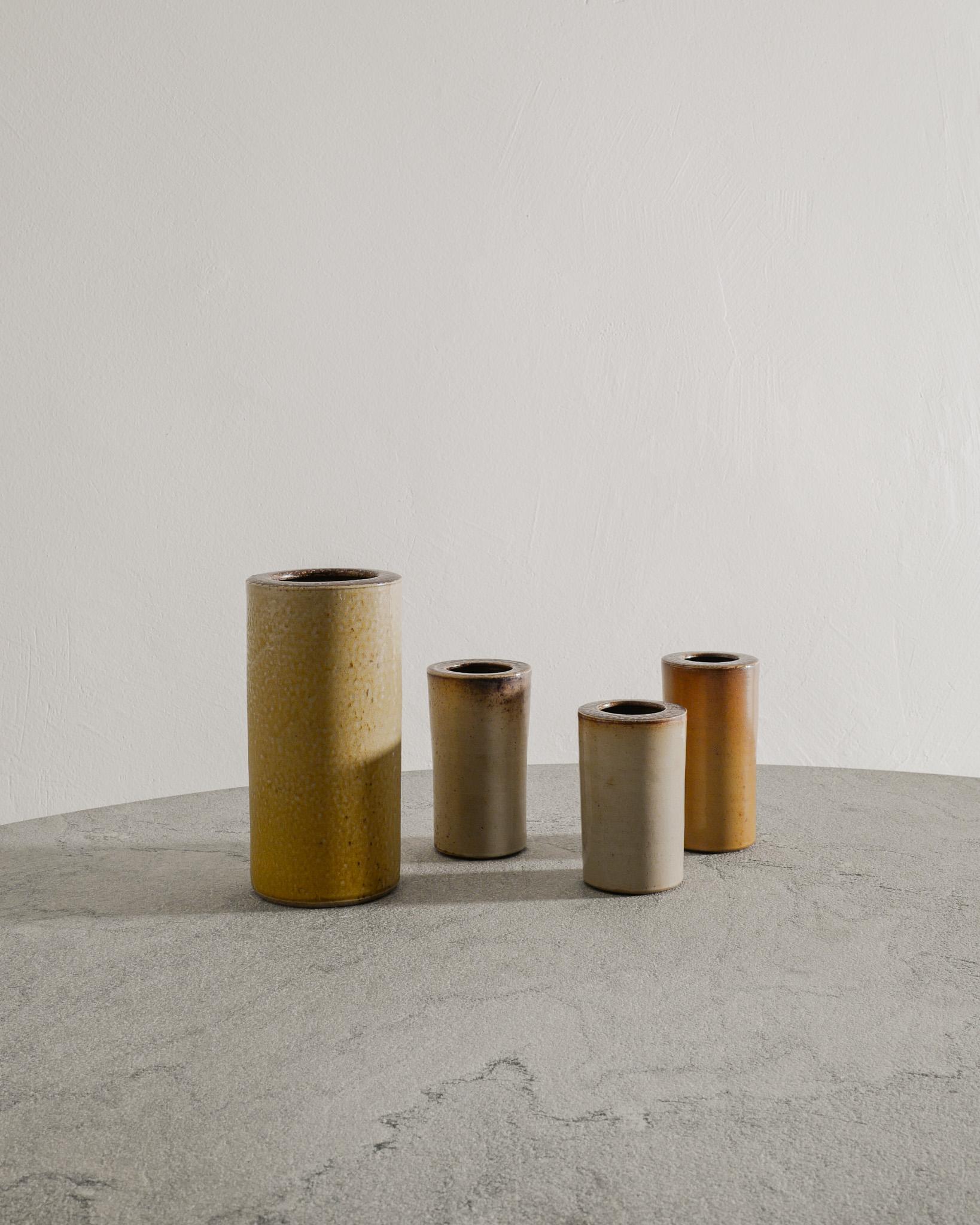 Rare set of four Swedish mid century cylinder round stoneware vases with earthy colored glazes by Arthur Andersson for Wallåkra Sweden, 1940s. In good original condition and all four vases are stamped with Wallåkra. 

Dimensions: H: 11-20 cm /