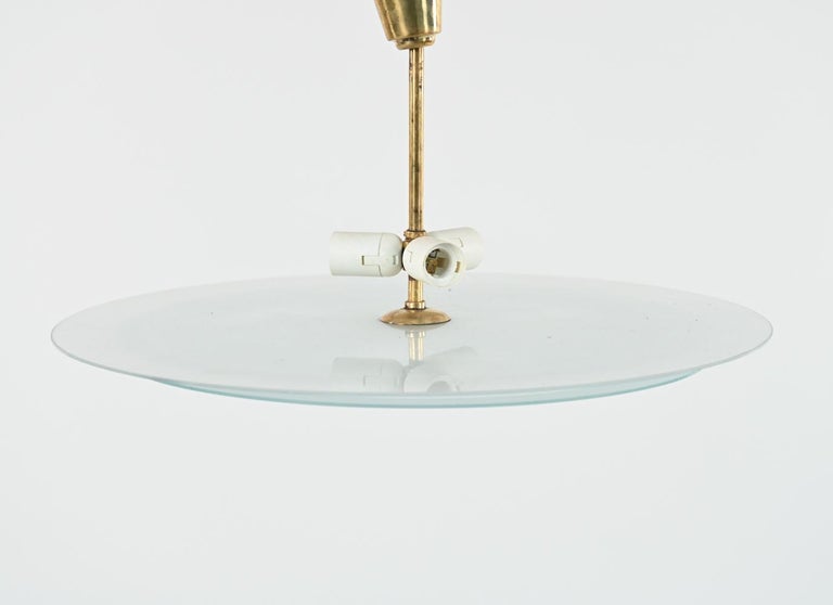 A fabulous Swedish mid-century saucer-form pendant chandelier feature two frosted glass 