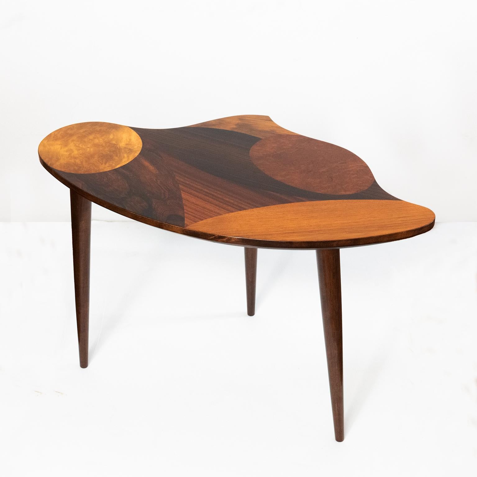 A unique Swedish mid-century occasional / side table with marquetry in variety of wood species, including: walnut, rosewood, elm root-wood & Macassar ebony. The surface has an irregular contour with gentle curves. Made in Sweden, circa 1950’s,