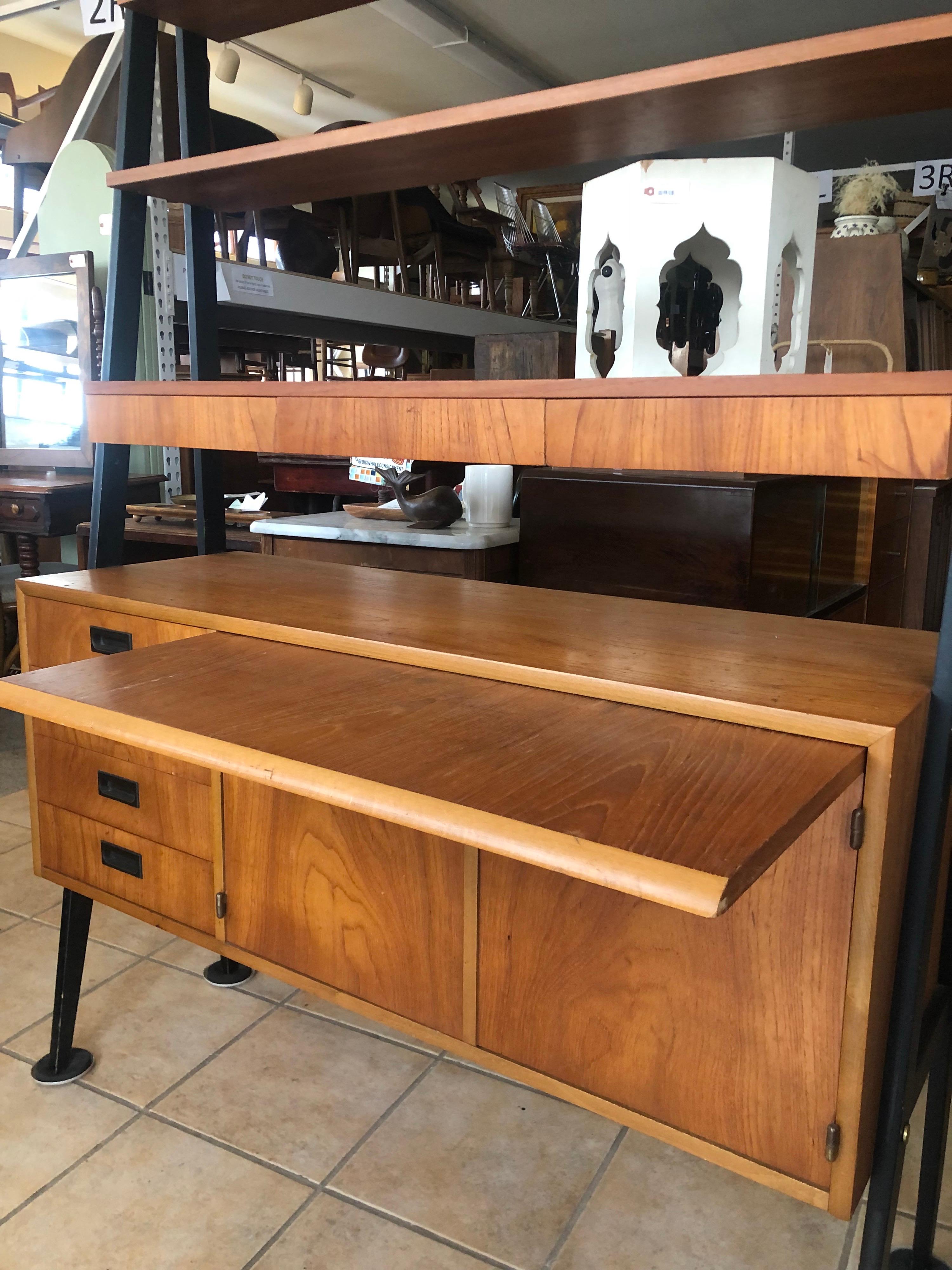 Swedish 1960’s sloping teak bookshelf with finished back

3 x shelves, floating 4 drawers, pull-out writing desk.

Overall dimensions: 45.5 W 16 D 65 H

Cabinet dimensions: 27.5 W 15 D 14.24 H. The shelf inside the record compartment is