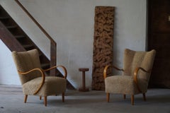 Swedish Mid Century Modern, A Pair of Lounge Chairs in Elm & Lambswool, 1960s