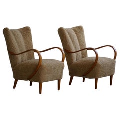 Swedish Mid Century Modern, A Pair of Lounge Chairs in Elm & Lambswool, 1960s