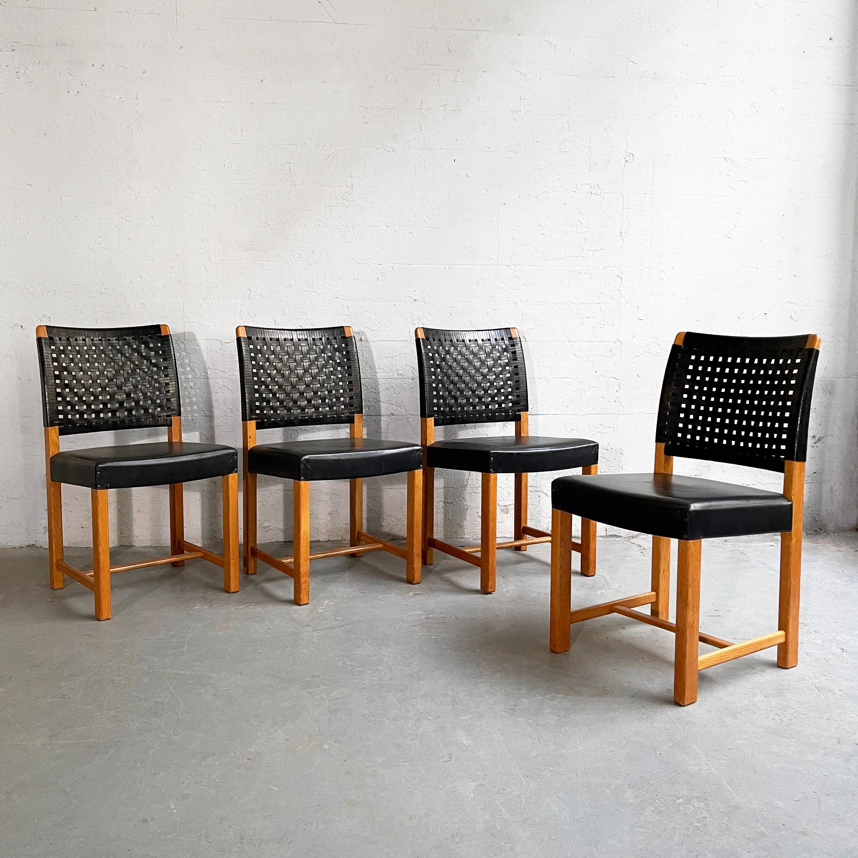Set of four side dining chairs feature black woven leather backs with black leather seats.