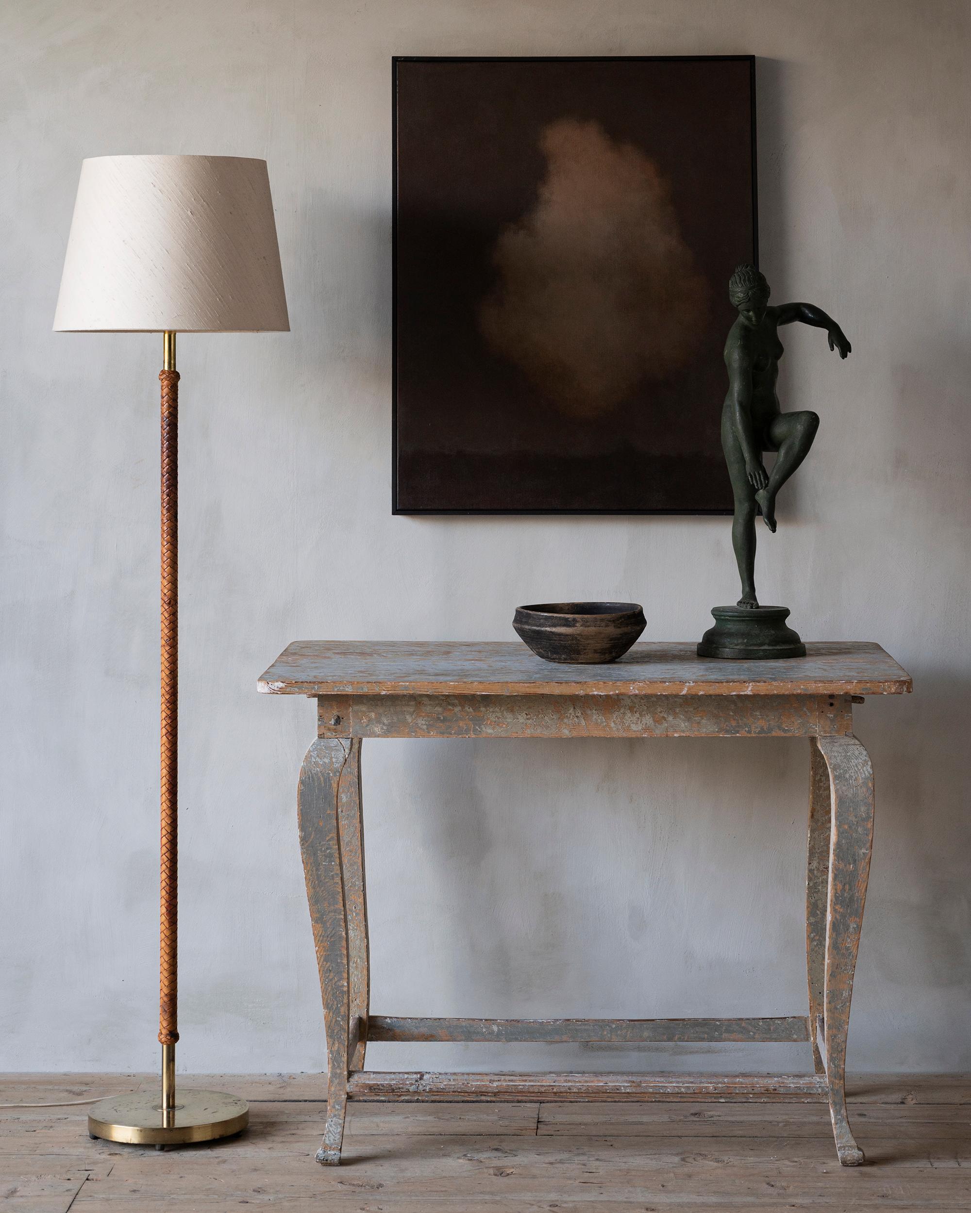 Swedish mid-century modern brass and braided leather floor lamp with It's original lamp shade, attributed to Bertil Brisborg for Nordiska Kompaniet NK. ca 1940s Sweden. 