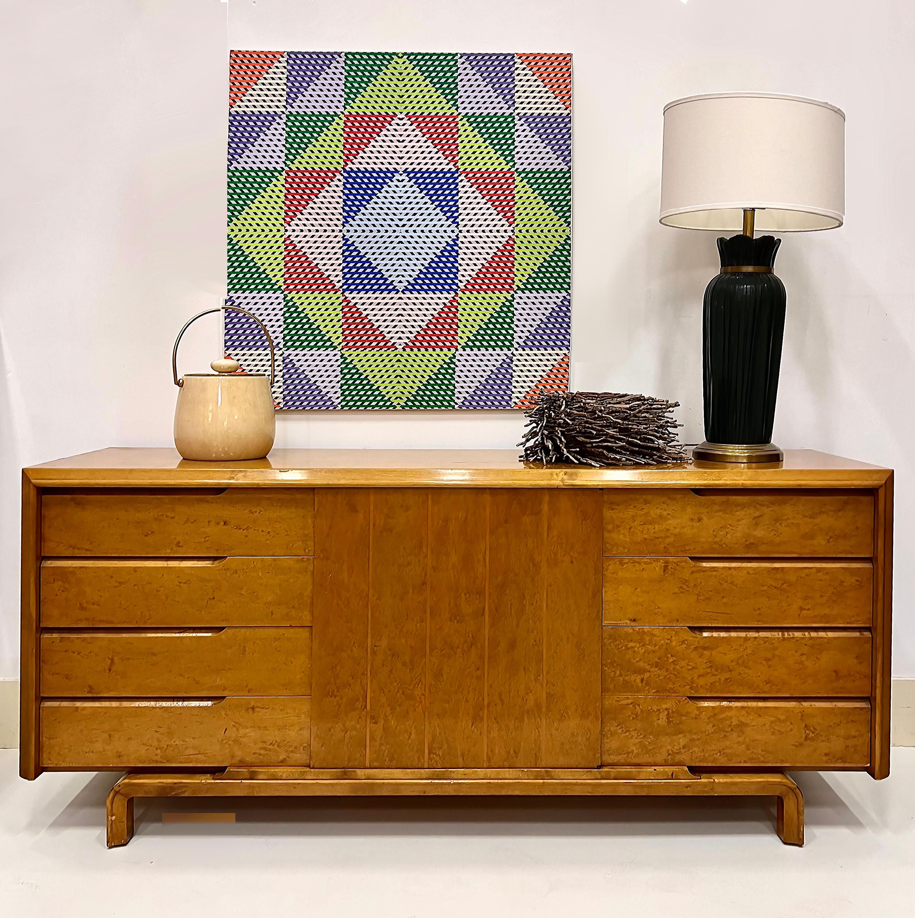  Swedish Mid-century Modern Edmond Spence Credenza with 9-drawers

Offered for sale vintage Swedish Modern Edmond Spence credenza that is substantially created in birch.  The credenza has 9 drawers with 3 being behind a center door. The cabinet has