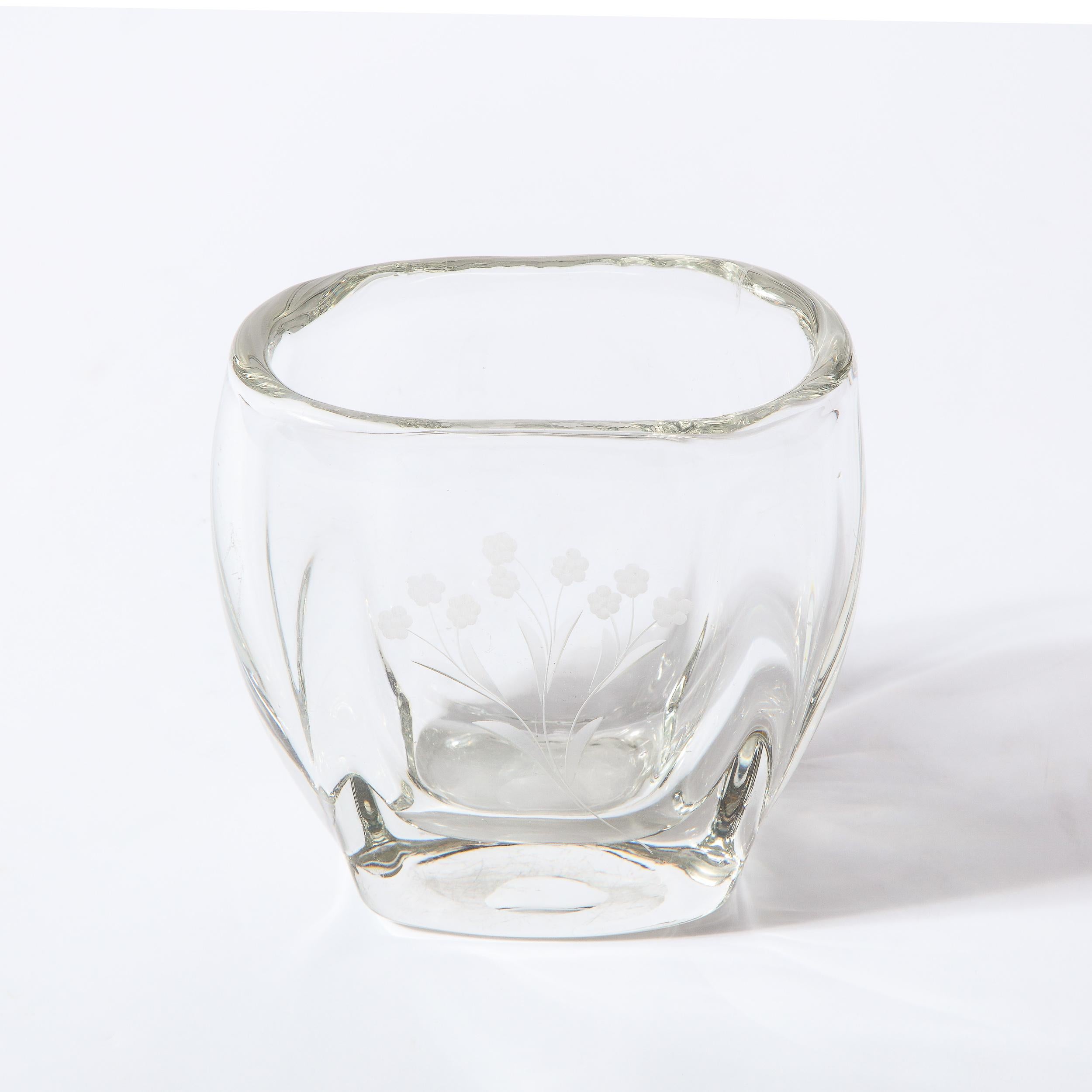 This stunning Mid-Century Modern vase was realized in Sweden circa 1960. It features an ovoid mouth and a rounded body in translucent glass with a stylized floral motif etched in frosted glass onto one side. With its clean modernist lines and