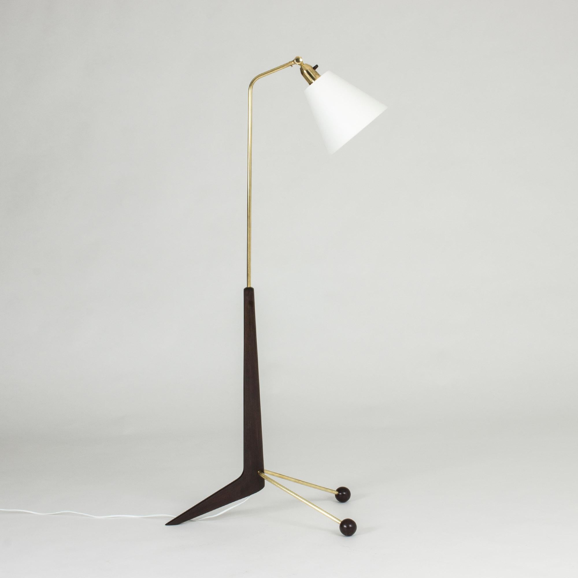 Cool Swedish 1950s floor lamp, made from brass and lacquered wood in a graphic shape. Cool u-shaped base with wooden balls at the ends.