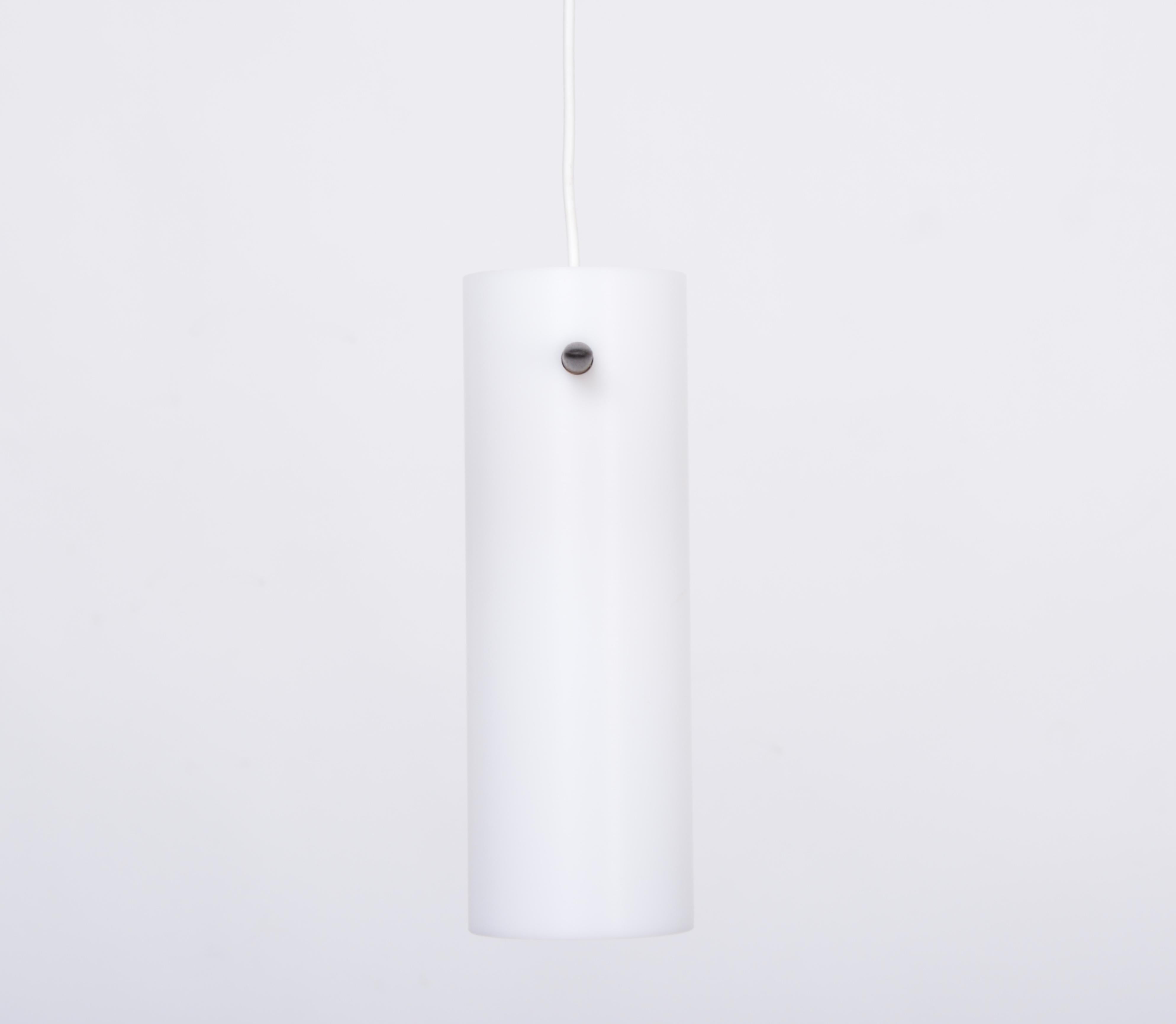 This minimal Mid-Century Modern pendant lamp or hanging light was designed by Swedish brothers Uno & Östen Kristiansson and produced by their company Luxus in Vittsjö, Sweden. This model is number 535 and was designed in the 1950s. It features a