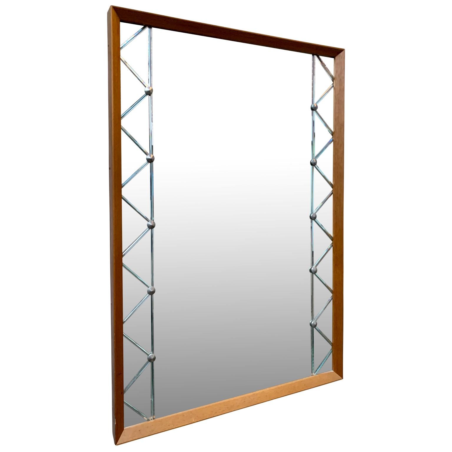 A vintage oakwood midcentury rectangular wall mirror.
This Swedish mirror from circa 1950s-1960s is made by KSG Karlshamn. Central portrait mirror flanked either side by smaller mirrored panels, held in place by stainless screws in studs and