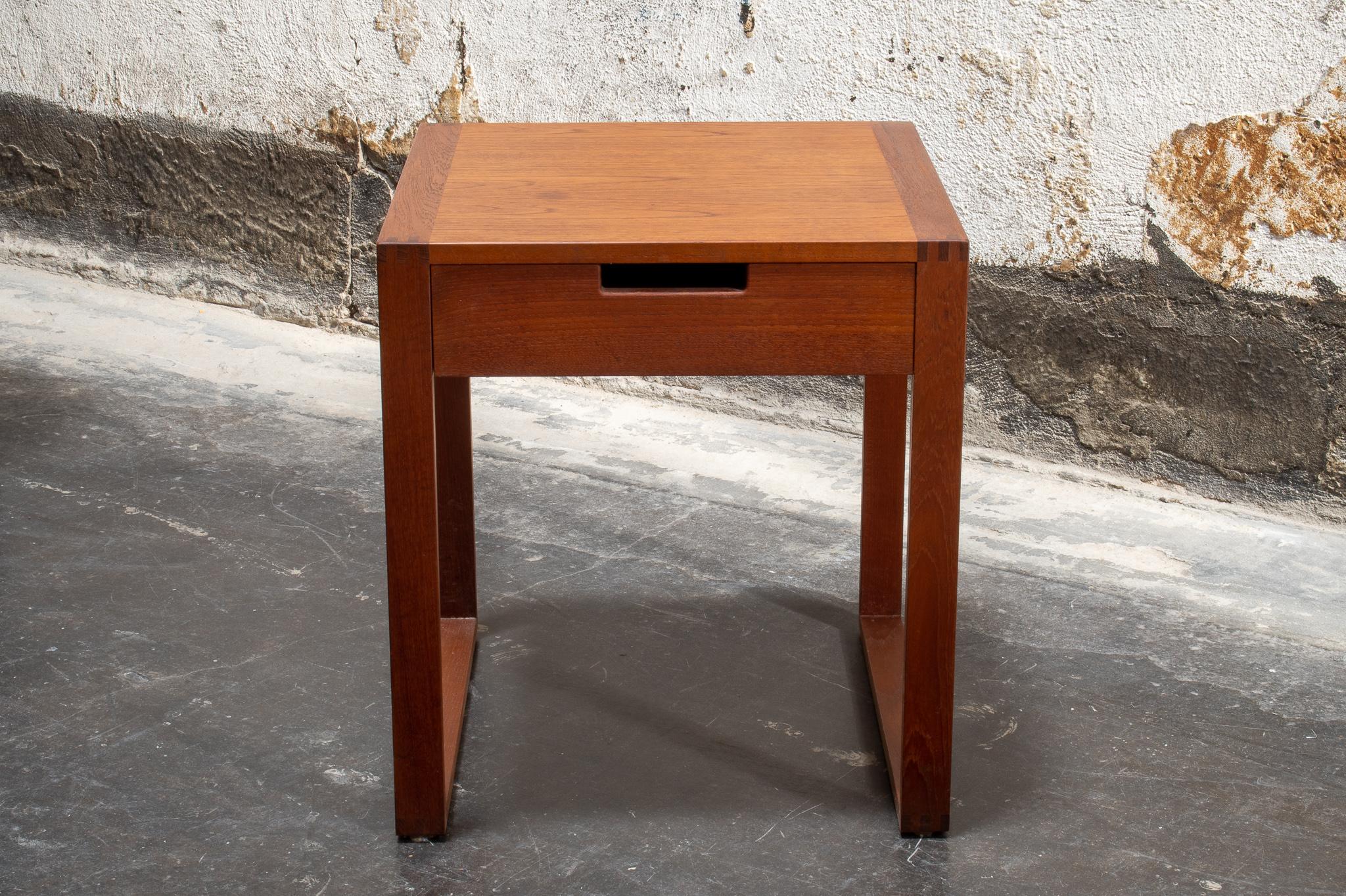 Mid Century Modern nightstand from Sweden, circa 1960. This Scandinavian teak side table has  u-shape table legs, and a small dovetail joined drawer. This Swedish Modern table is perfectly sized for use as a Minimalist bedside table or as a small