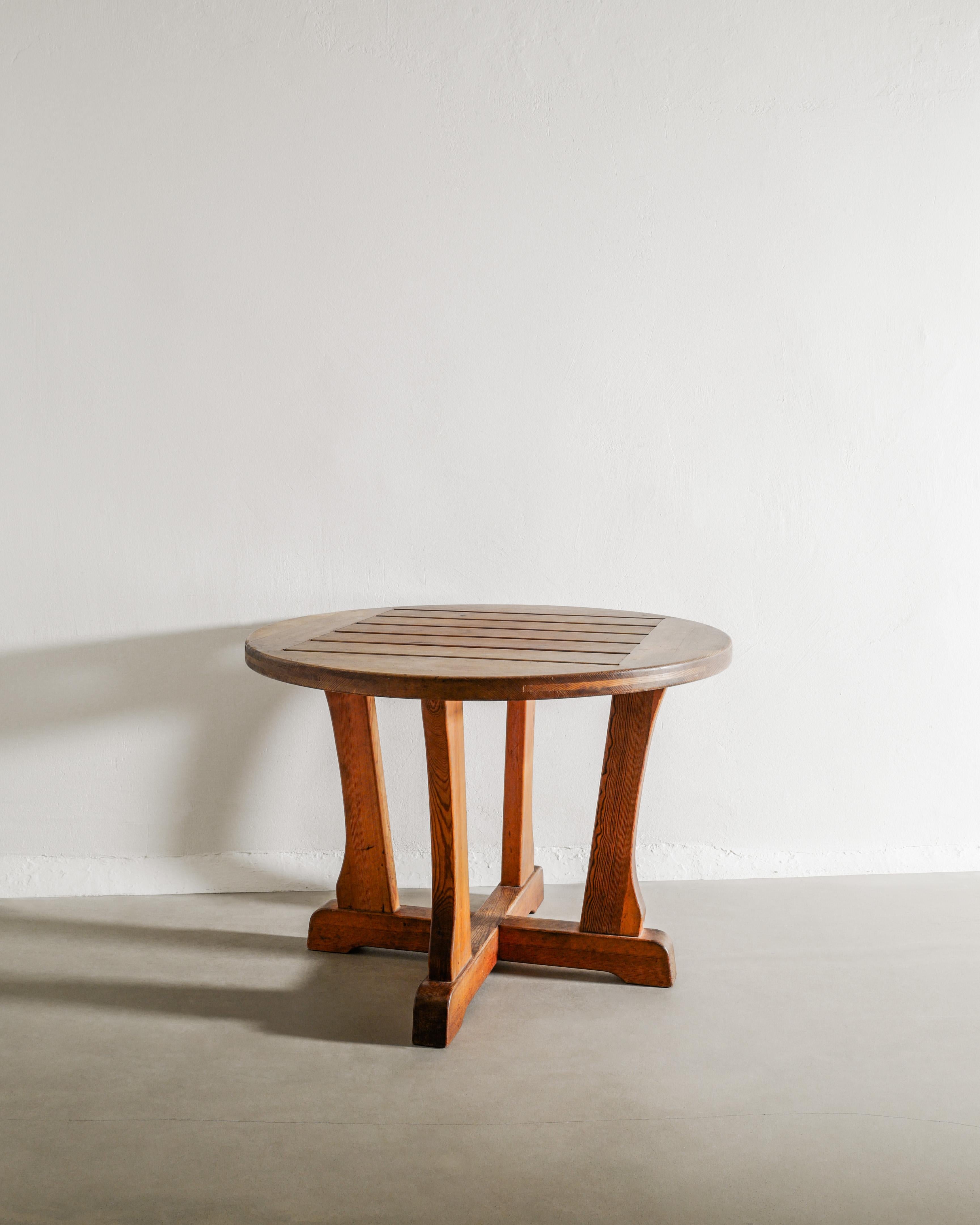 A very rare Swedish modern round console center dining table in brown stained pine wood from the 