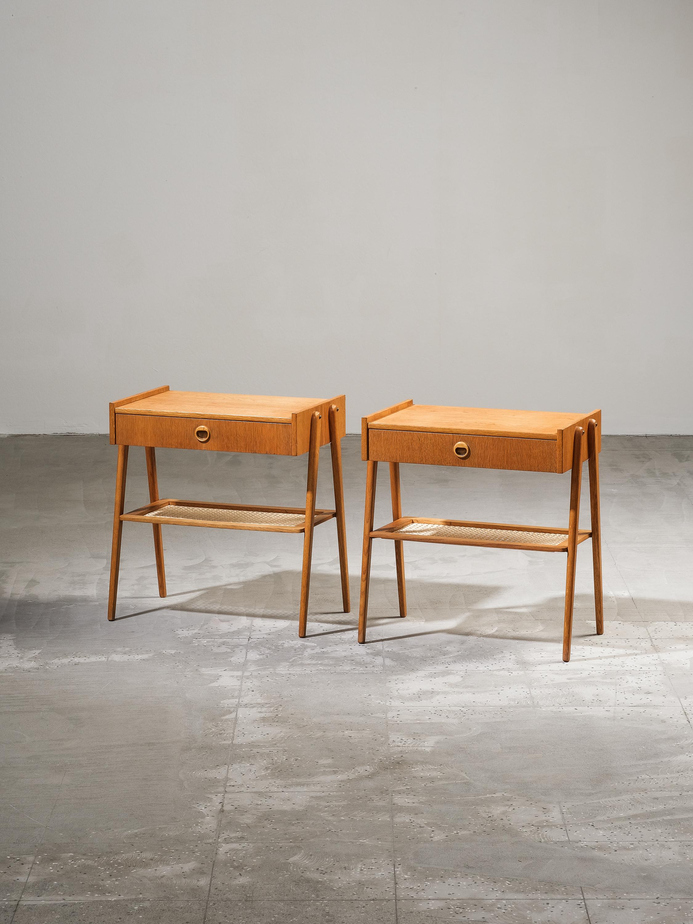 Stylish and sophisticated Swedish mid-century oak & rattan bedside tables from the 1960s. Crafted with premium materials, these bedside tables offer both functionality and elegance.