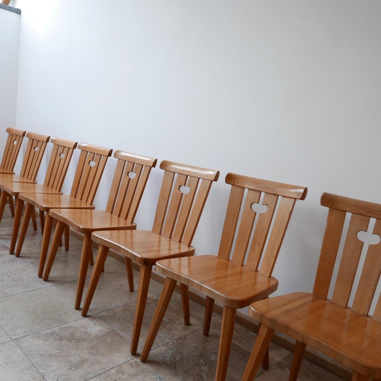 A good run of eight dining chairs.

Sweden, circa 1960s.

Pine construction which is a good blonde color.

Stands on tapered legs.

Possibly by Svensk Fur.

Some scuffs and wear, but good condition.

Dimensions: 43 W x 38 D x 45 seat