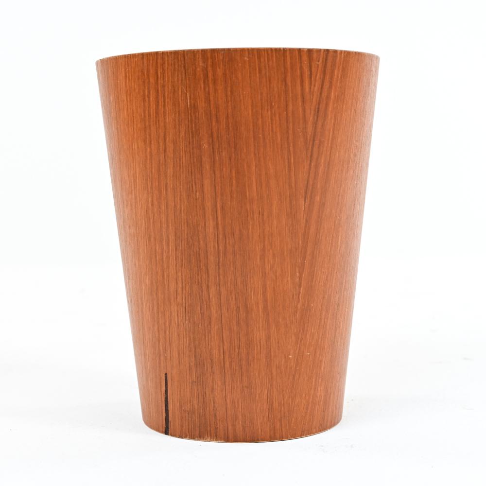 A fabulous Swedish mid-century teak veneered waste basket by Rainbow Products, stamped with manufacturer's mark underneath. A charming Scandinavian modern accent piece.