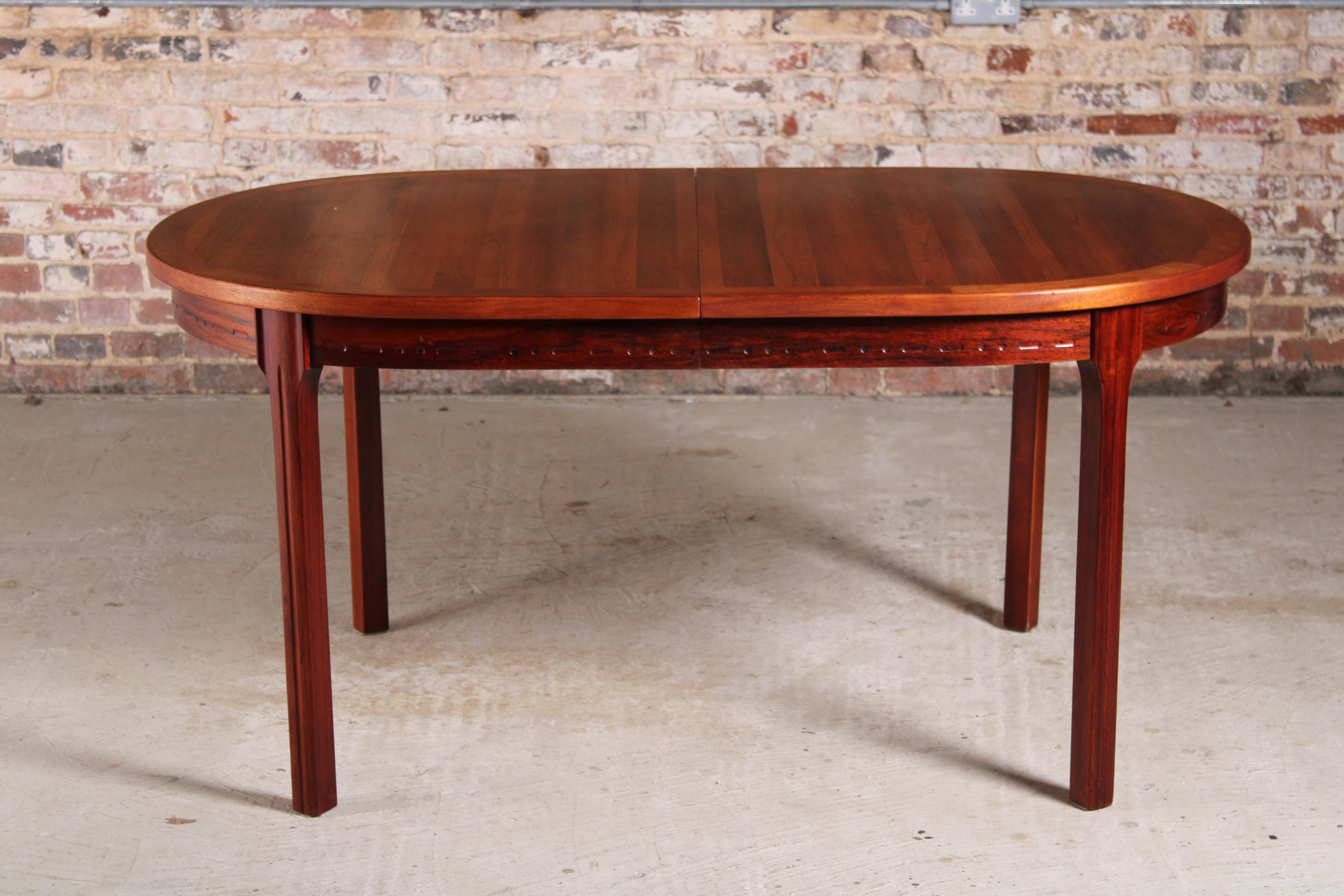 Swedish Mid Century rosewood dining table by Nils Jonsson for Troeds, circa 1970s. 2 extension leaves stored underneath. Extends to 266cm and seats up to 12 people. 

Measures: W 156/211/266cm
D 100cm
H 73cm.
