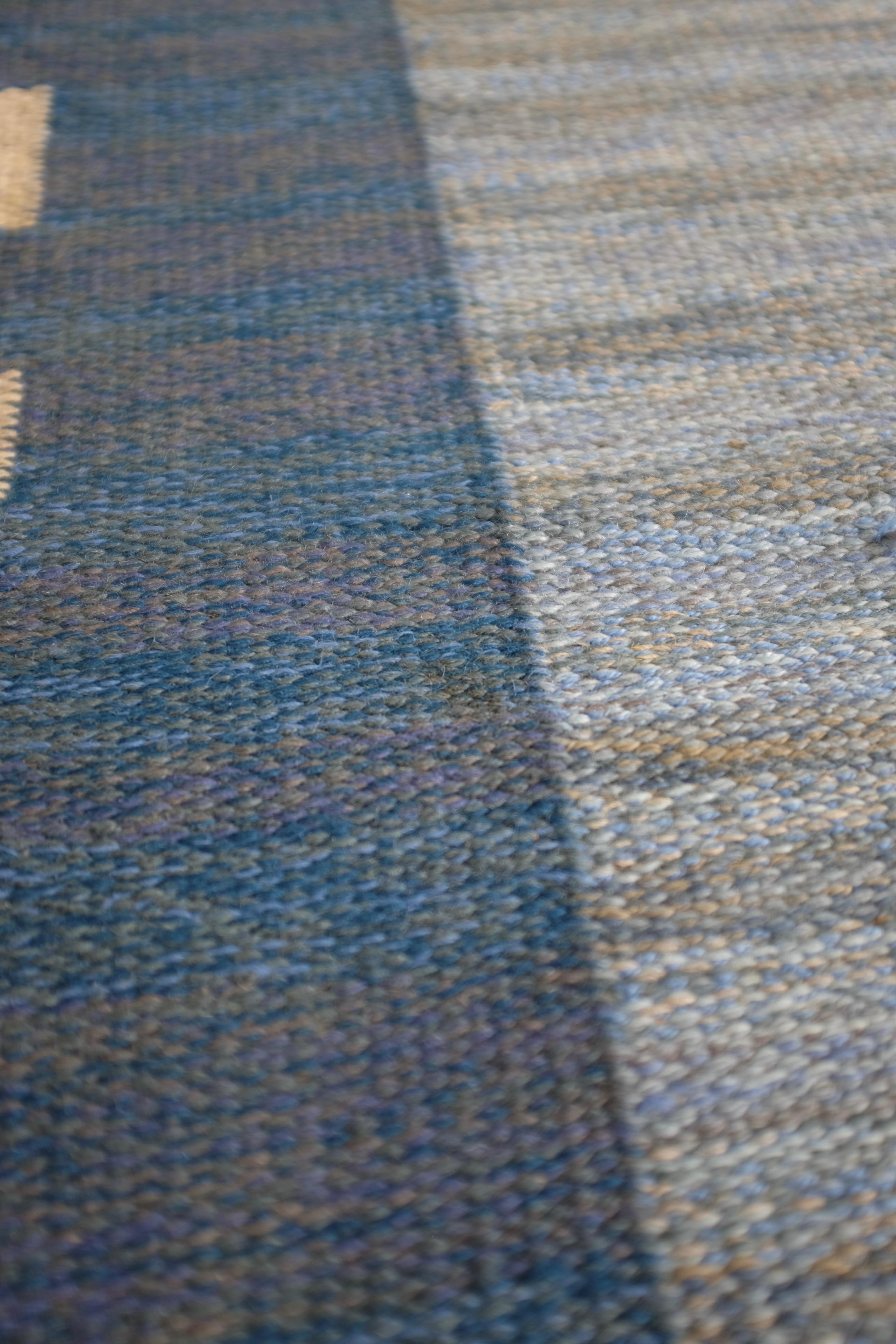 Handwoven Mid-Century rug by Swedish Textile designer Aina Kånge with a blue, brown, and white shades in a neo classic inspired pattern. As usual in Aina Kånge designs the pattern is classic and timeless. Her initials are visible at the lower right