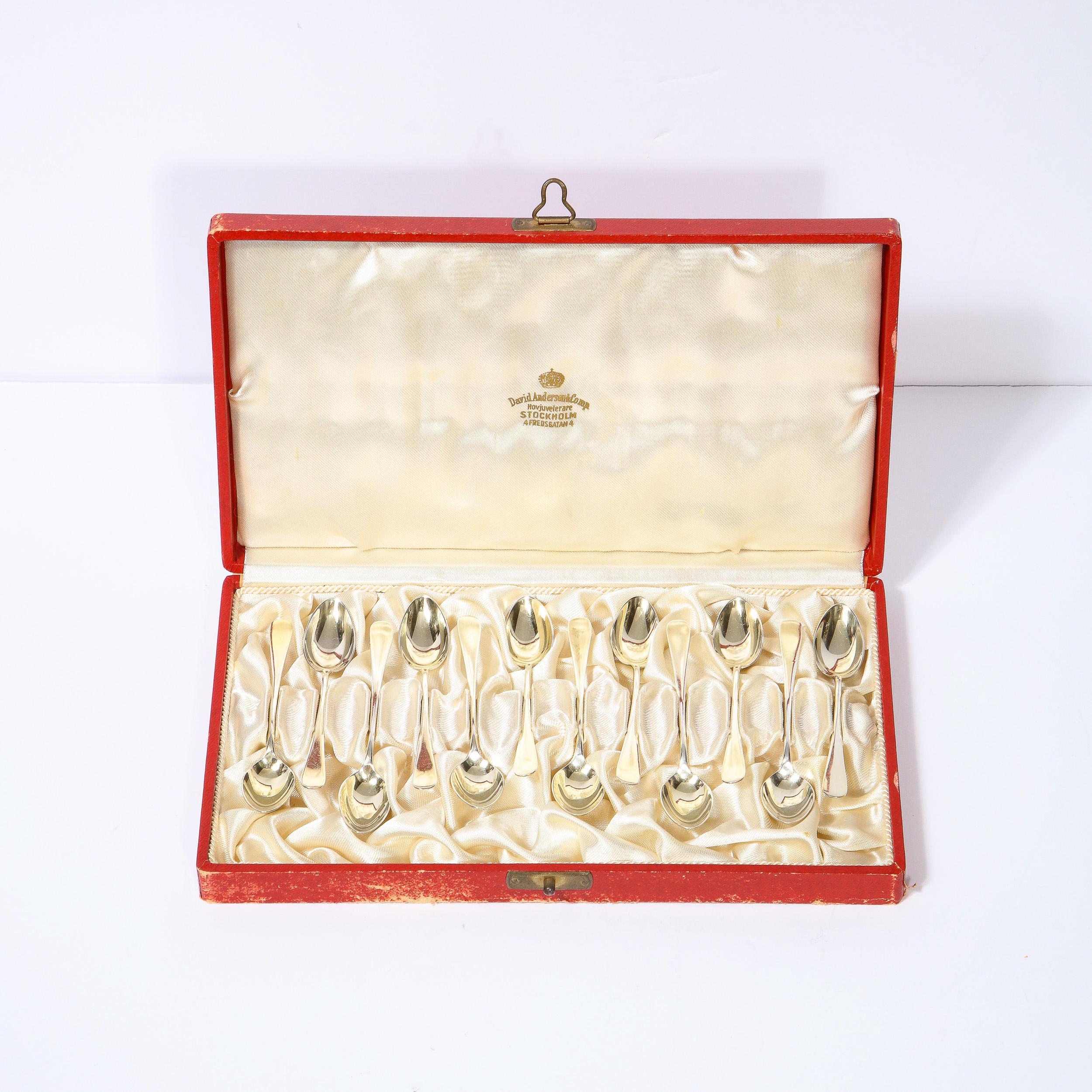 This stunning set of 12 demi tasse gilt sterling silver spoons were realized by the fabled atelier of Swedish designer David Andersen circa 1950. They feature rectangular handles that flare slightly to rounded ends, and concave rounded oval bowls.