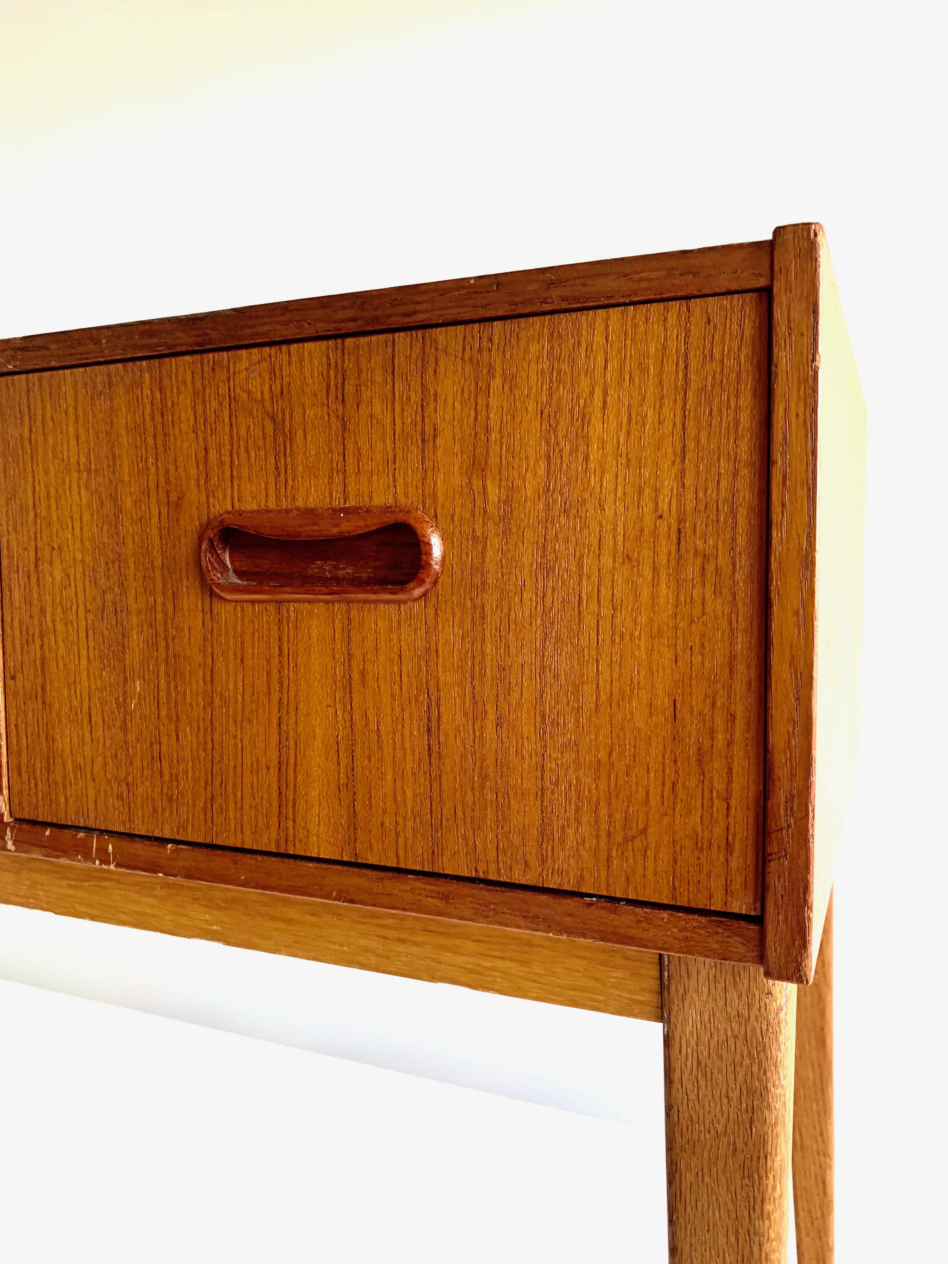 1960s Scandinavian Modern design chest featuring three drawers and tapered legs. 
The vintage piece is overall in good condition.