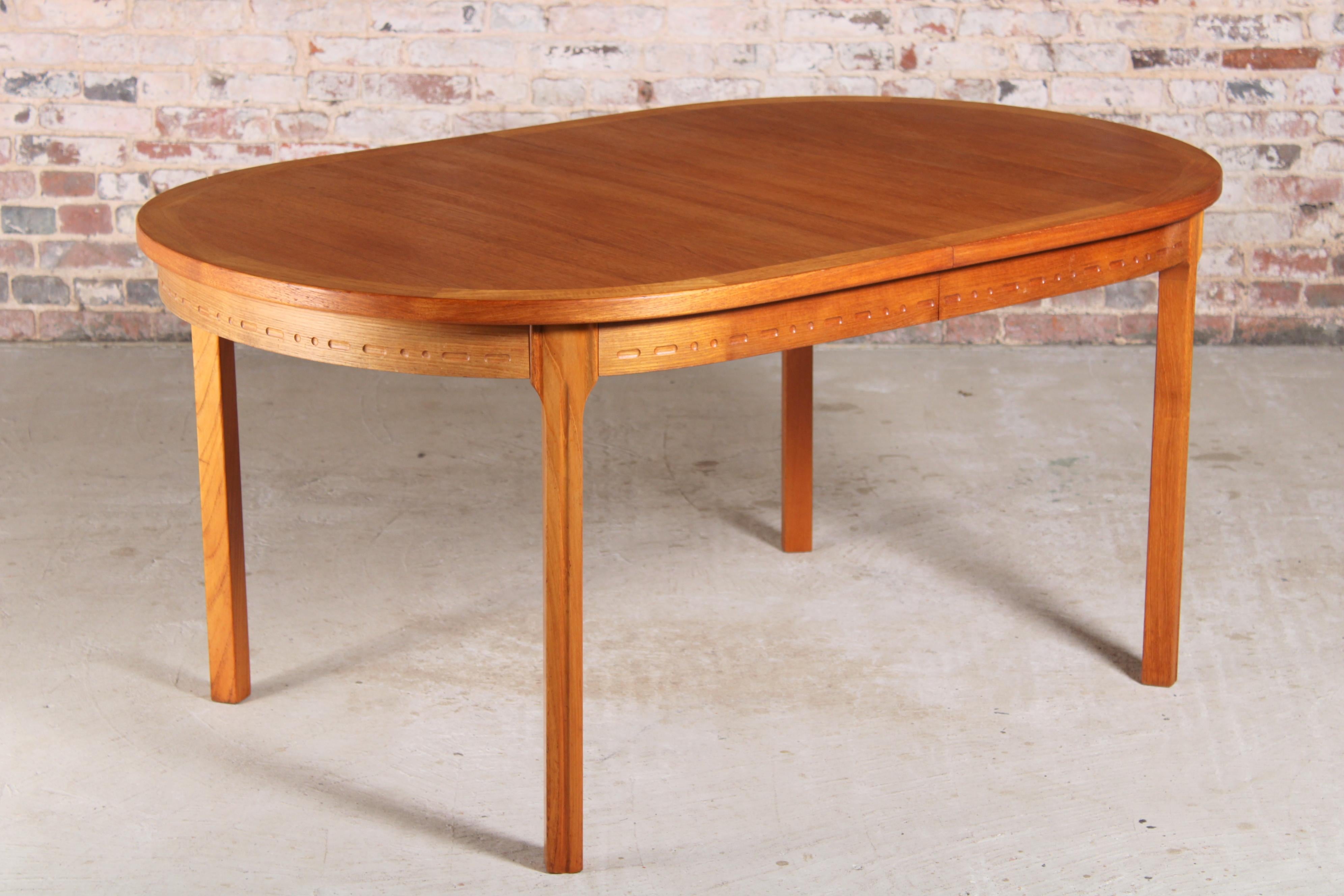 Swedish mid-century teak dining table by Nils Jonsson for Troeds, circa 1970s. 2 extension leaves stored underneath. Extends to 266cm and seats up to 12 people. Fully restored condition. 

Dimensions: 156/211/266 W x 100 D x 73 H cm.