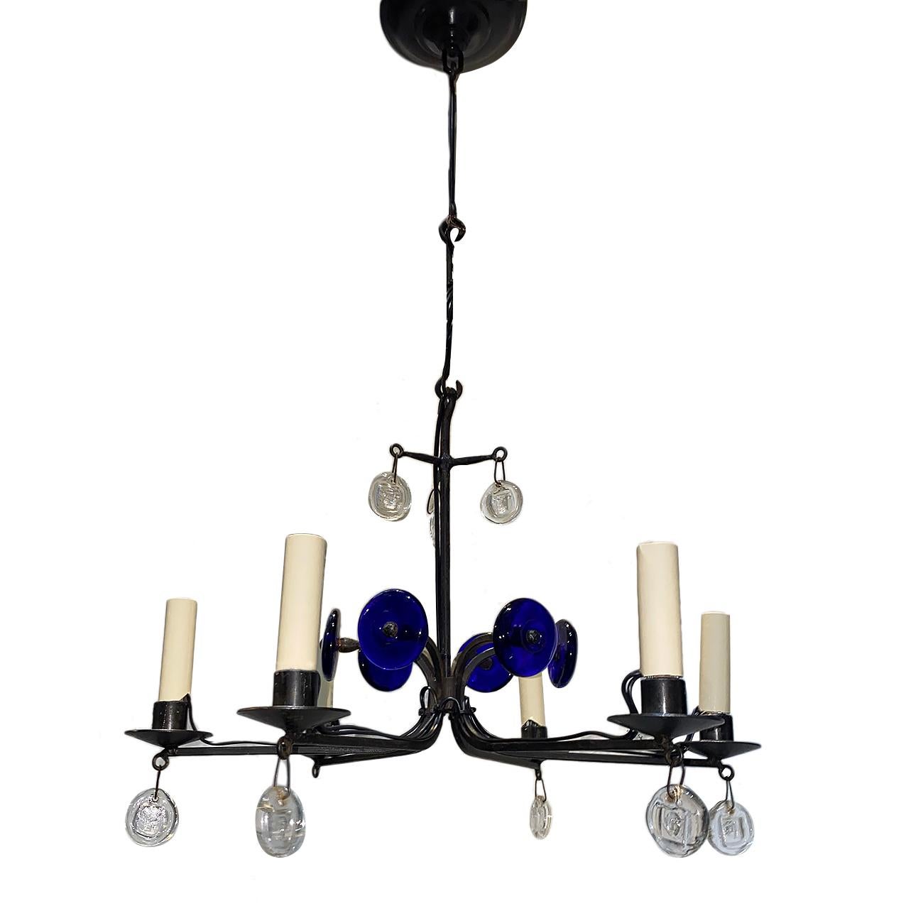 A circa 1960s Swedish wrought iron chandelier with glass pendants and blue glass elements.

Measurements:
Height 13