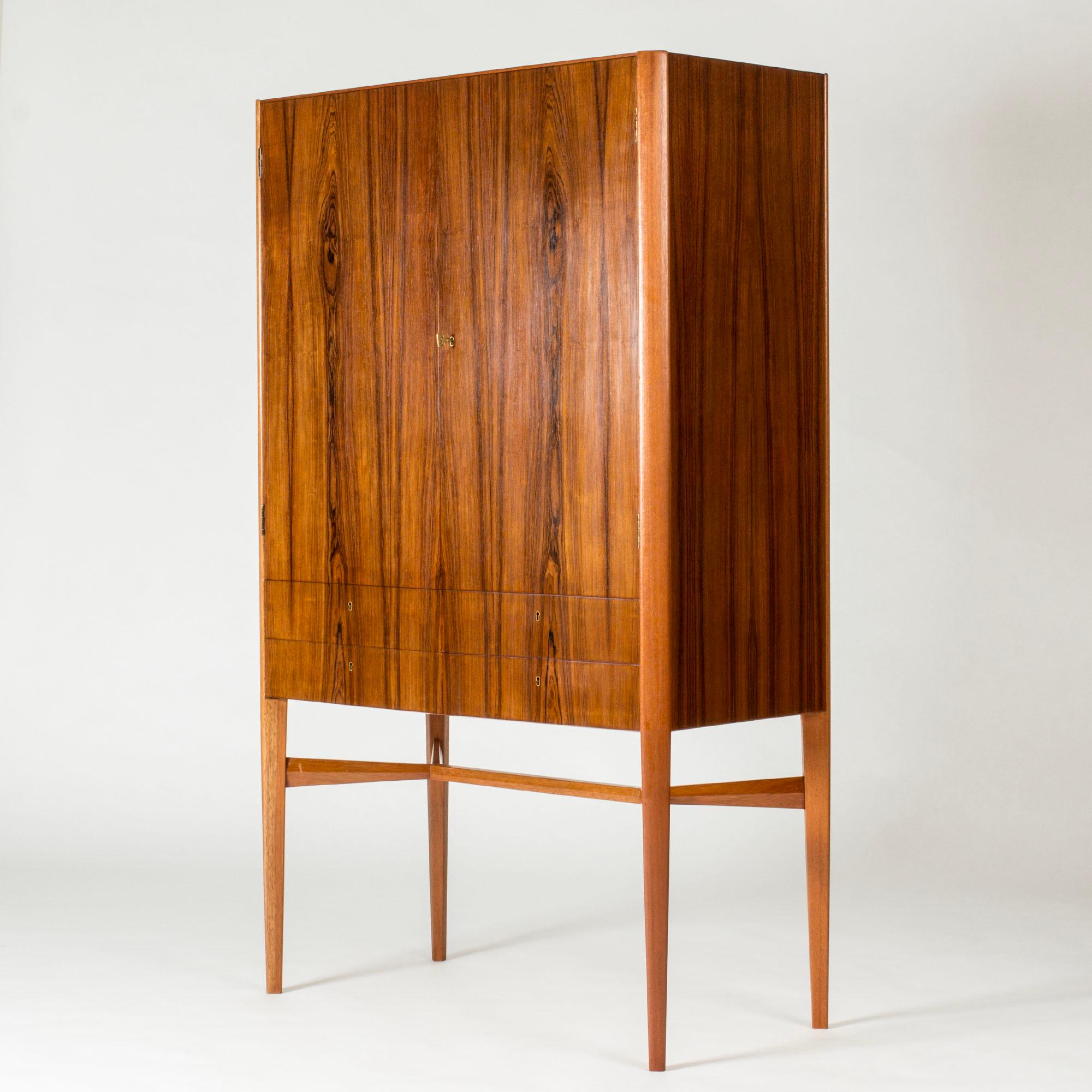 Striking rosewood cabinet by Carl-Axel Acking with sleek lines and beautiful woodgrain. Made as an apprentice’s exam with beautiful execution.