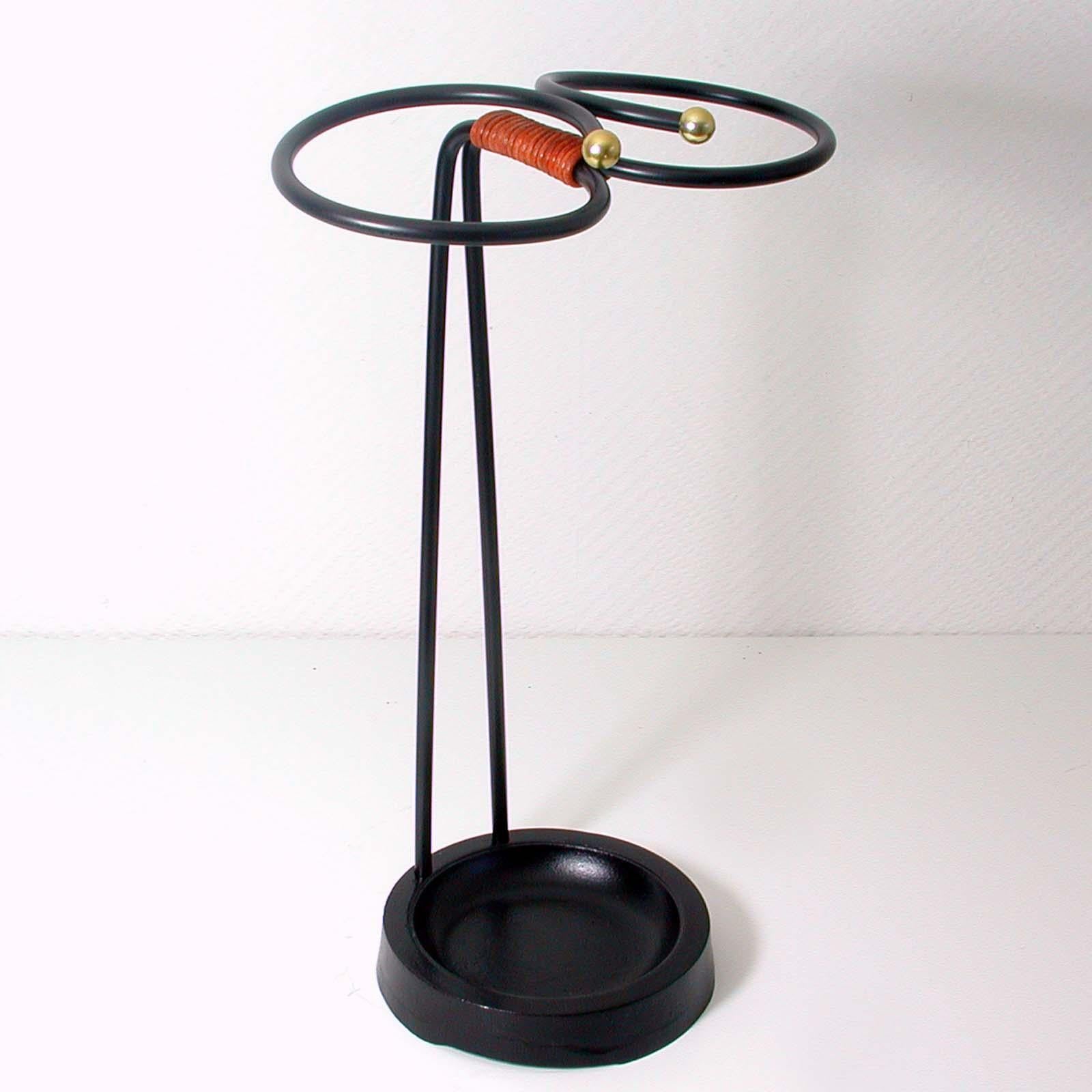 This stylish midcentury vintage umbrella stand was made in Sweden in the 1950s. It is made of black lacquered metal and has got a black lacquered cast iron base. The middle part is made of brown leather.

Condition is very good with minor signs of