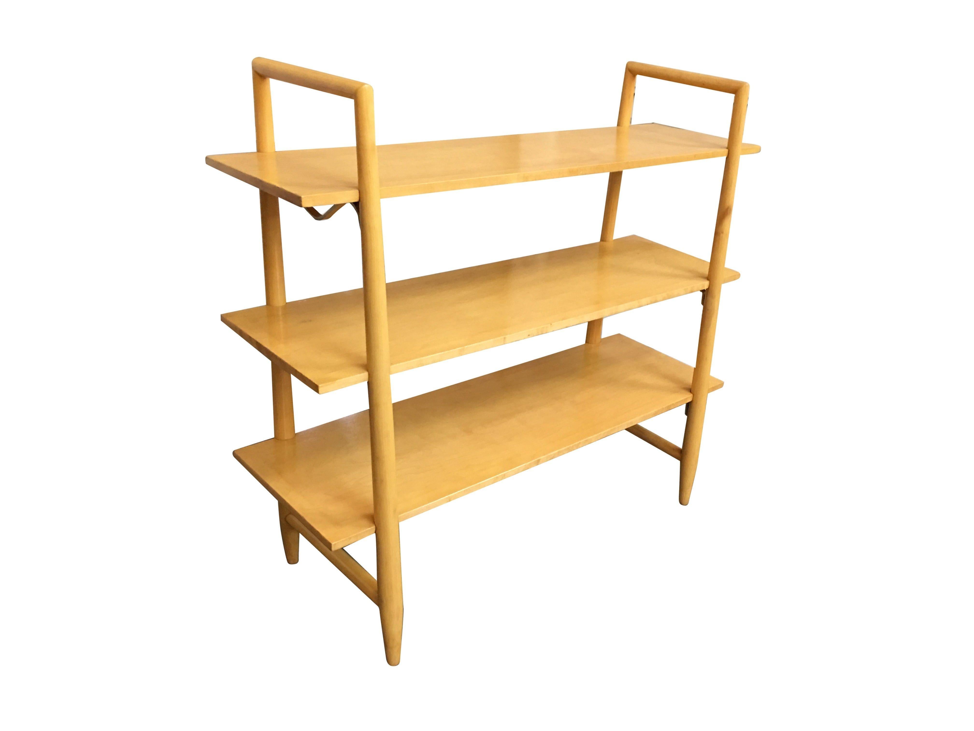 Swedish-made blonde Mid-Century Modern bookshelf pair with three floating shelves each designed by Edmond Spence for Walpole. Attractive joinery and a very usable size with great detail. The turned supports are inset to the shelves and there are