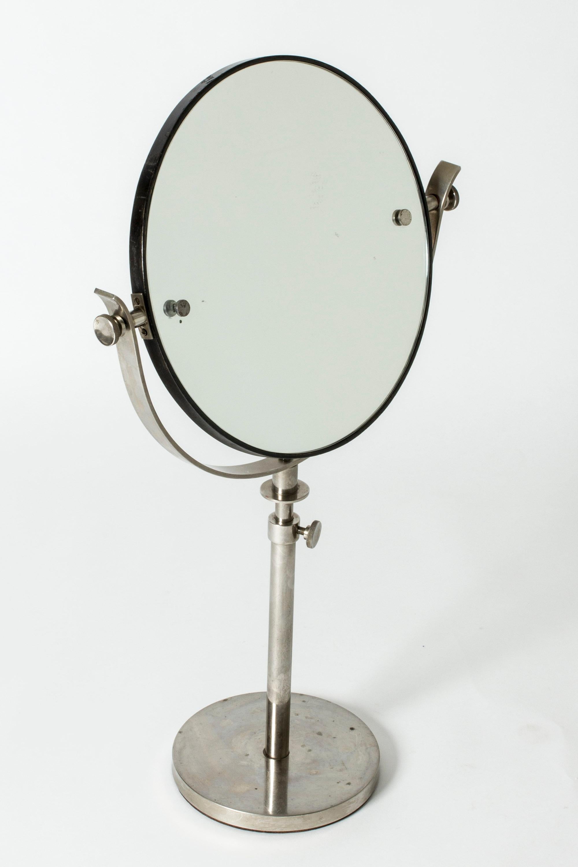 Elegant table mirror, with beautiful details. Made in white metal. Elongated design, adjustable height, 77-91 cm.