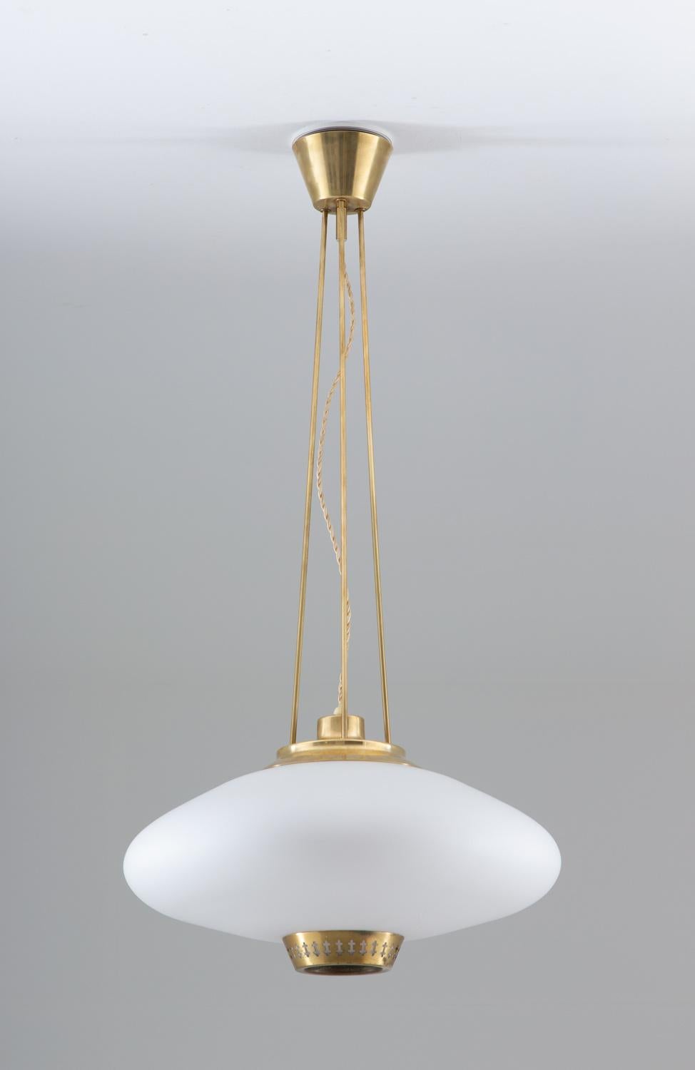 Midcentury pendant in brass and frosted opaline glass by Hans Bergström for ASEA, Sweden, 1950s.
This great looking pendant is made with the quality and details that Hans Bergström is famous for. The large opaline glass shade gives a soft, cozy