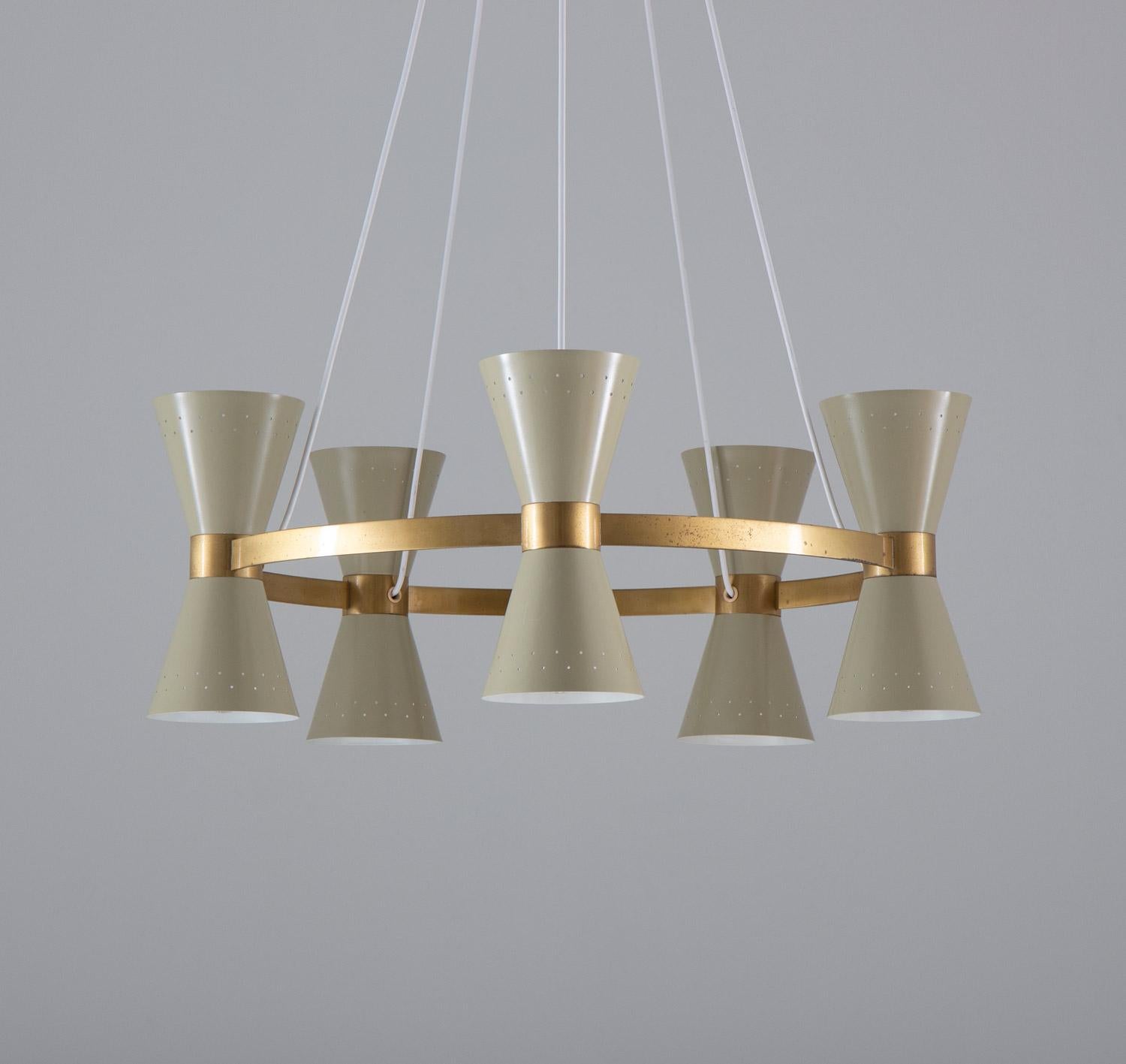 Rare chandeliers by Alf Svensson for Bergboms, Sweden, 1950s.
This beautiful chandelier consists of a solid brass ring, supporting 10 cone-shaped perforated metal shades, each of them hiding a light source.

Condition: Very good restored
