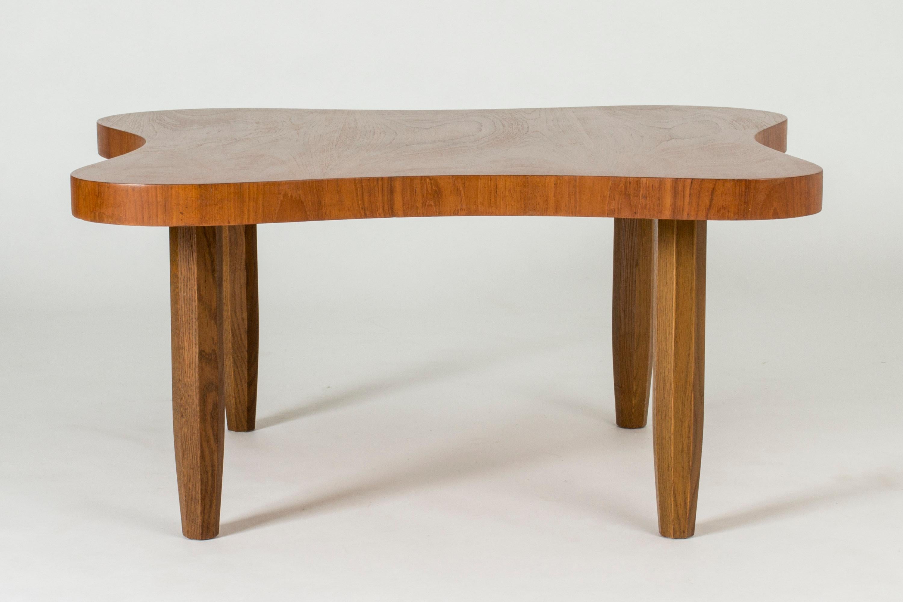 Beautiful Swedish modern coffee table by Sten Blomberg for Meeths, designed in 1942. Made in a stout form with an organic shaped table top. Lively teak wood, beveled legs.