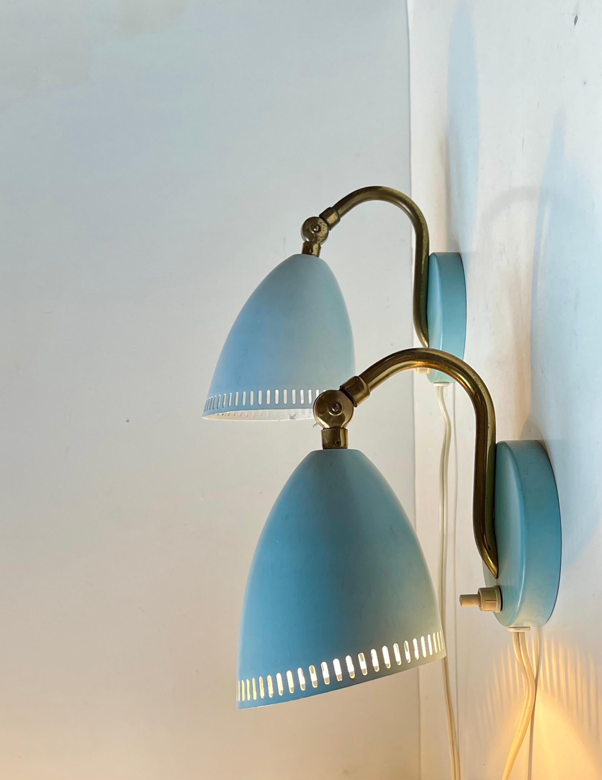 Im Stil von Stilnovo und der französischen Modernismus-Bewegung kommt hier ein Paar babyblaue Wandleuchten aus Aluminium mit Messing-Akzenten. Hergestellt in Schweden, ca. 1950-60. Alle Originalteile mit verstellbaren Zapfen und Bakelitbuchsen sowie