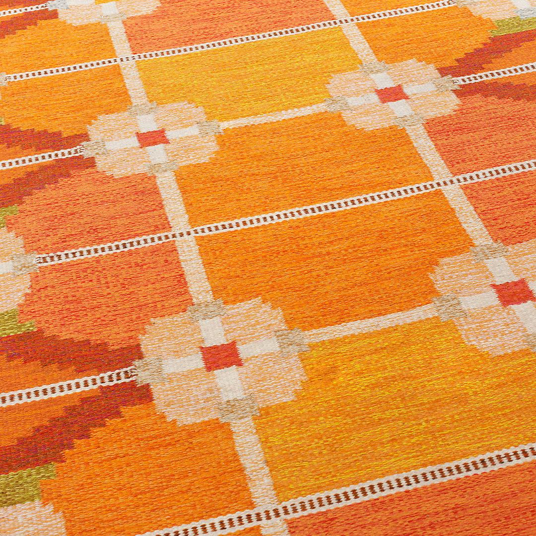 Swedish flat woven virgin wool Rug designed by Ingegerd Silow. Sweden, 1950s.
This extraordinary Kilin Technique rug features a geometric shapes pattern, a motif easily recognizable from the designer style, the different shades of bright orange,