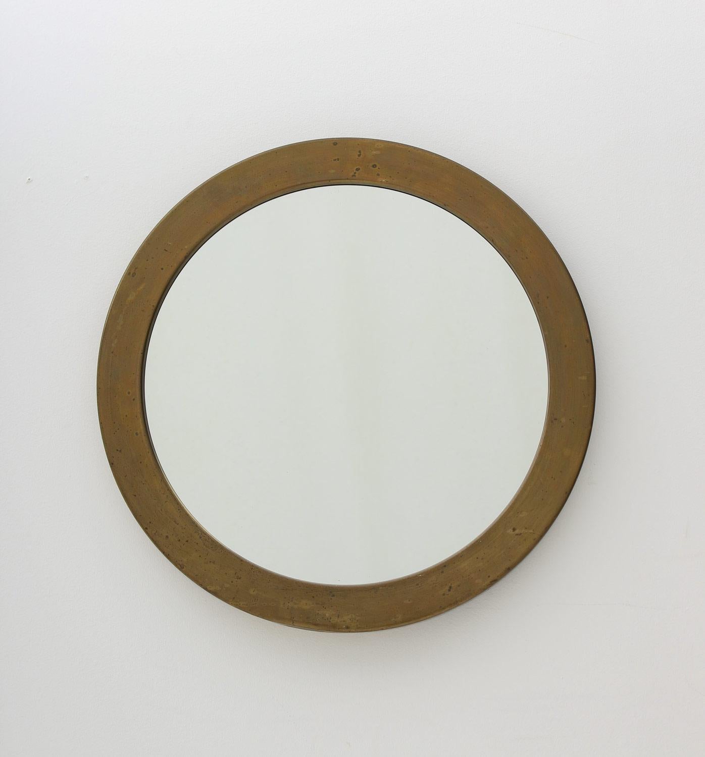 Beautiful round mirror, produced by Glasmäster Markaryd, Sweden. 
Large brass frame with awesome patina. 

Condition: Good original condition. The frame shows a nice warm patina. A dent on the lower part of the frame. Mirror glass in excellent