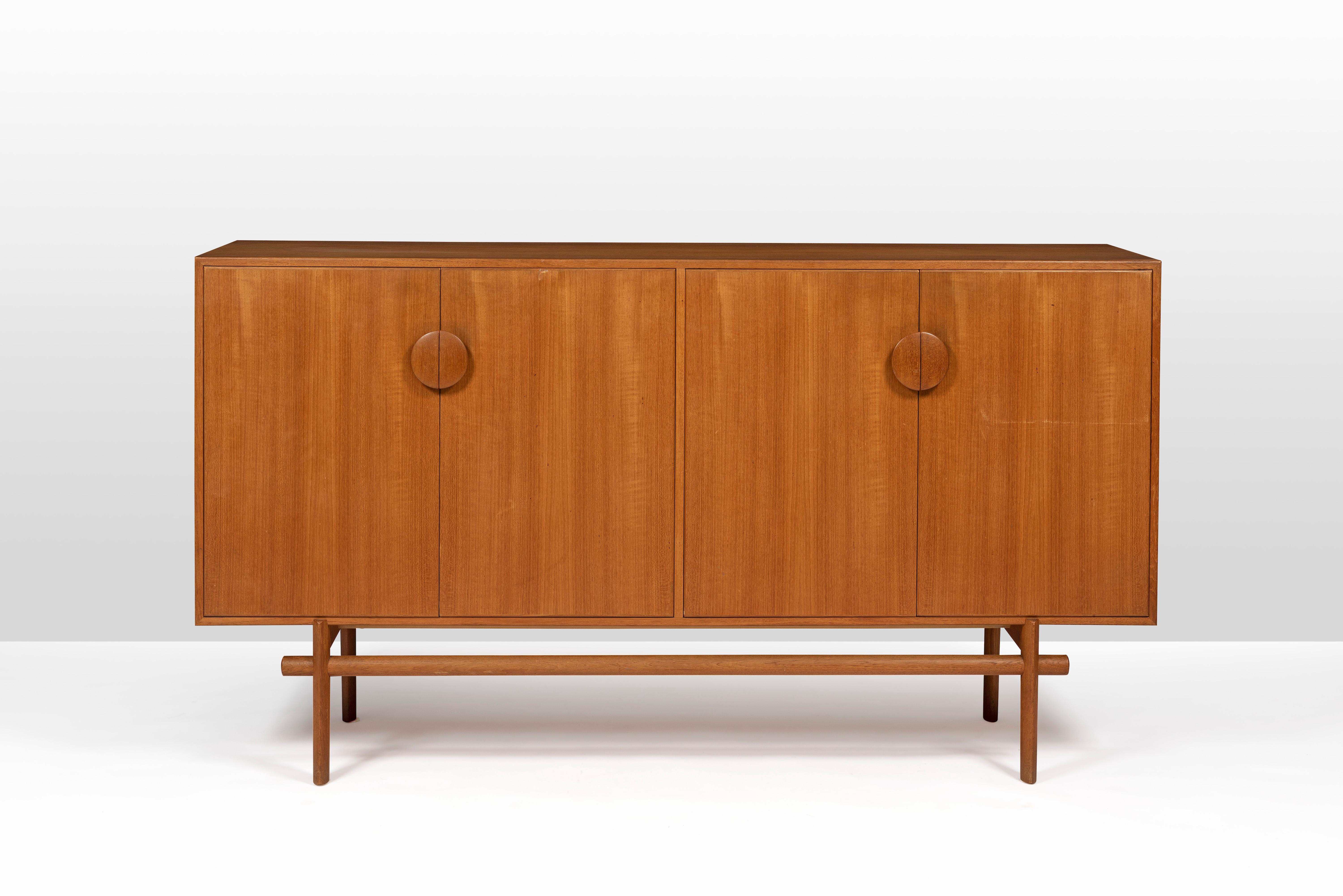 Danish designer couple Tove and Edvard Kindt-Larsen designed this cabinet with drawers in 1961. Both Tove (1906-1994) and Edvardt (1901-1982) Kindt-Larsen were trained as architects. During their marriage and partnership as architects and furniture
