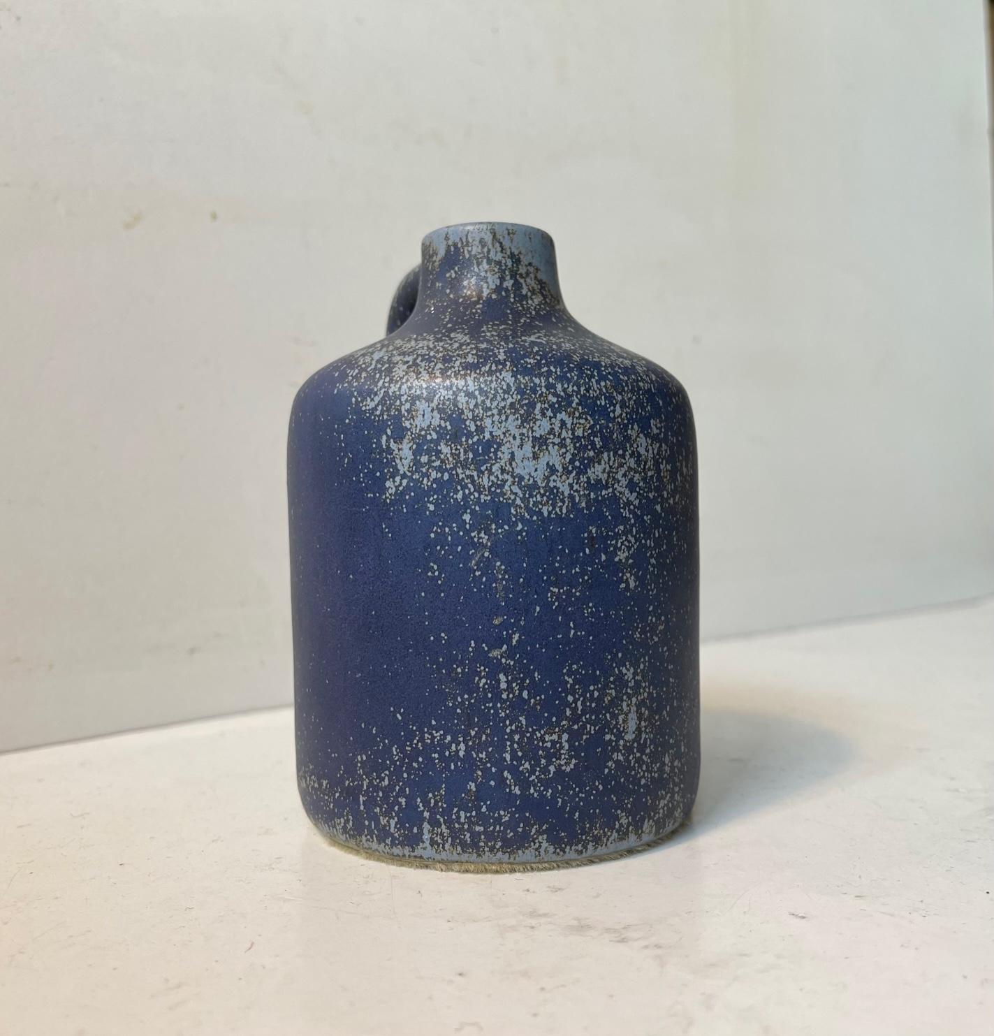Small unidentified Swedish ceramic vase with delicate speckled blue glaze. Very similar to pieces by Gunnar Nylund, Carl H. Stahlhane and Rolf Palm. We have not removed the Suede cover to its bottom so who know whos signature will be revealed.